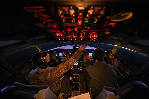 U.S. Air Force Capt. James Huff, 351st Air Refueling Squadron group mobility chief of operations, and Capt. Wilson Spreier, 100th Operations Support Squadron mission planning officer, prepare the KC-135 Stratotanker aircraft flight simulator prior to starting the Tanker Heist competition at Royal Air Force Mildenhall, England, Feb. 11, 2021. More than 60 aircrew members participated in the event, breaking into 20 teams of two pilots and one boom operator. (U.S. Air Force photo by Staff Sgt. Mackenzie Mendez)
