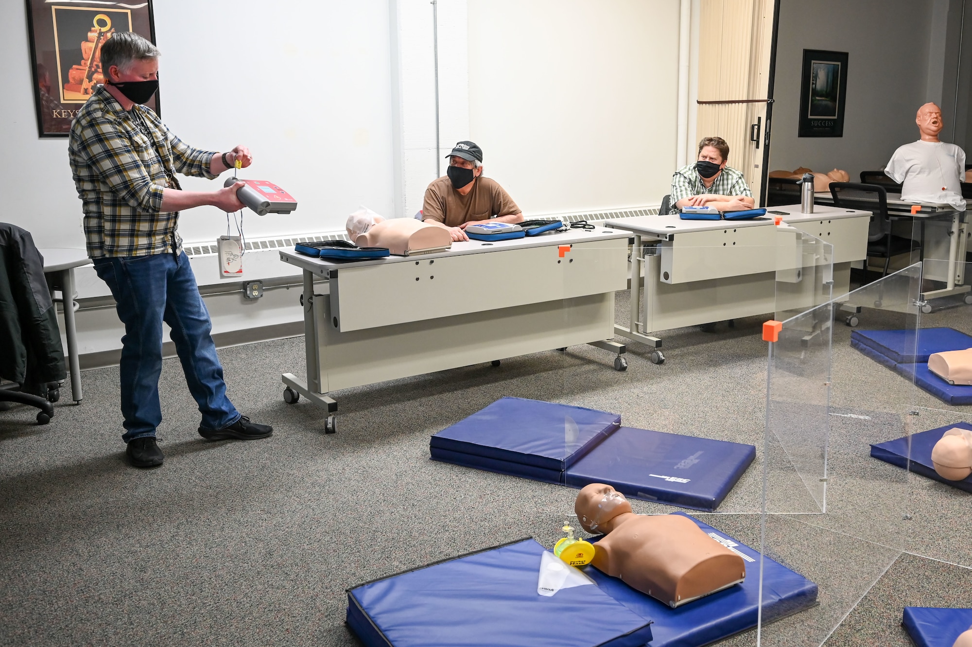 Instructor Jason Bertoldie, 75th Force Support Squadron, demonstrates an automated external defibrillator (AED) during the cardiopulmonary resuscitation, or CPR, class Feb. 8, 2021, at Hill Air Force Base, Utah. The CPR class is one of the several classes still being offered with modifications from 75th FSS's Education and Training Center. (U.S. Air Force photo by Cynthia Griggs)