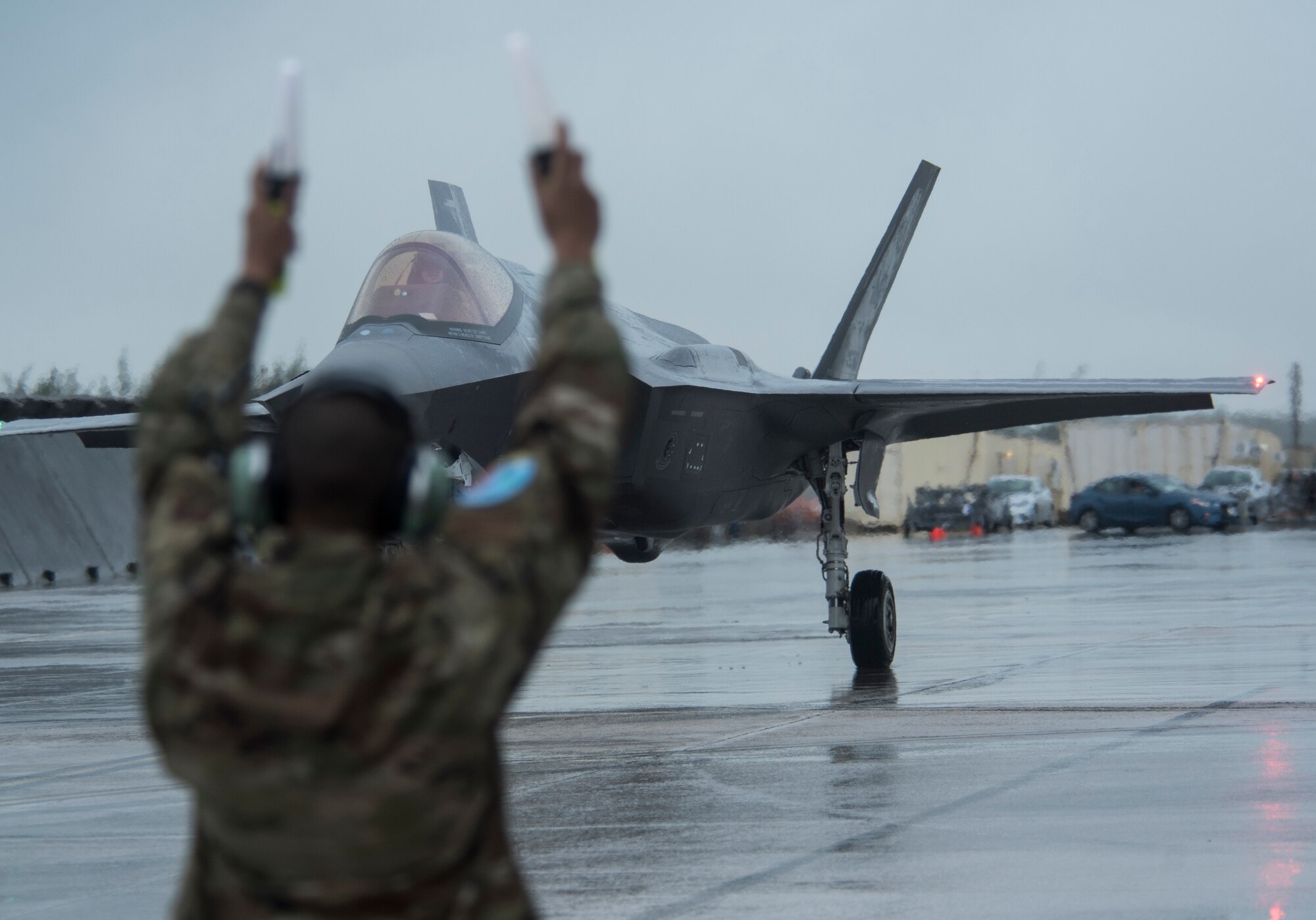 An Airman from the 356th Aircraft Maintenance Unit at Eielson, Air Force Base, Alaska, marshalls an F-35A Lightning II, also from Eielson AFB as part of Cope North 21 at Andersen AFB, Guam, Feb. 6, 2021. Approximately 2,200 personnel and 97 aircraft were brought together for Cope North 21 with the mission to improve combat readiness, increase interoperability between U.S. Air Force, Royal Australian Air Force and Japan Air Self-Defense Force, or Koku-Jieitai. (U.S. Air Force photo by Senior Airman Jonathan Valdes Montijo)