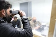 A truck driver undergoes an iris scan at Erbil Air Base, Iraq, Feb. 5, 2021 conducted by Chief Warrant Officer Lente, the officer in charge of the Syrian Logistics Cell military intelligence team or S-2. All drivers partake in the iris scan in addition to a fingerprint scan and a review of their record.