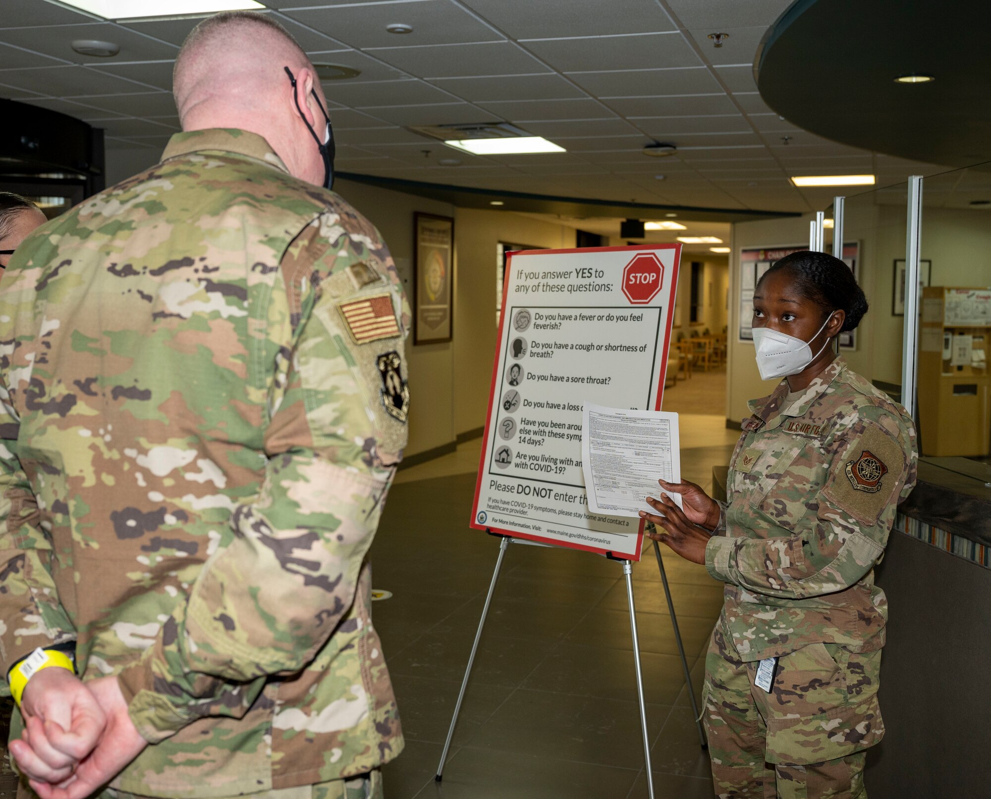 Staff Sgt. Brianna Holden, 436th Medical Support Squadron outpatient records noncommissioned officer in charge, explains the COVID-19 screening process implemented by the 436th Medical Group to Chief Master Sgt. Chad Bickley, 18th Air Force command chief, on Dover Air Force Base, Feb.11, 2021. The 436th Medical Group has implemented various procedures in response to COVID-19, including virtual appointments and new pharmacy procedures. (U.S. Air Force photo by Airman 1st Class Cydney Lee)