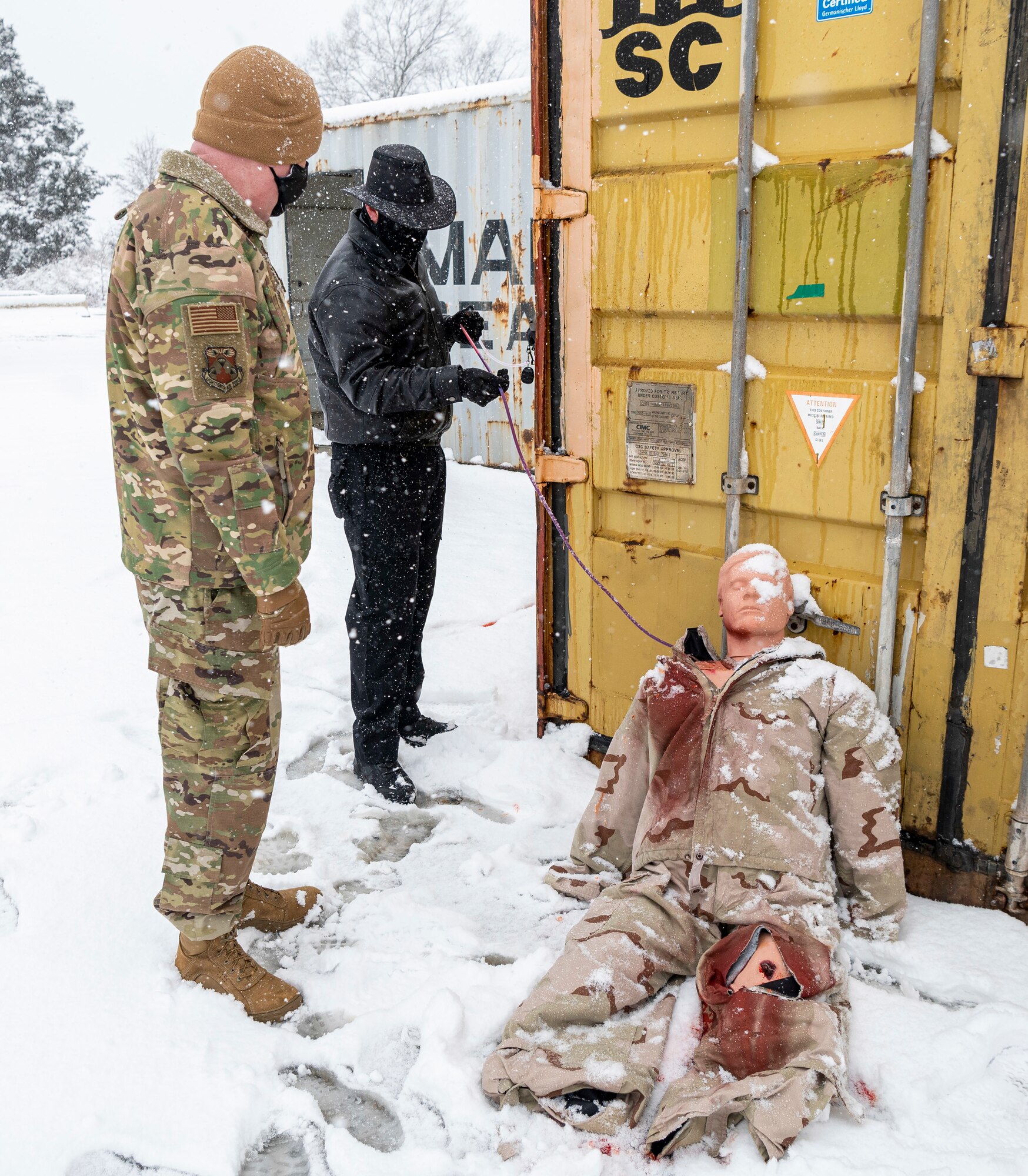 Ken Jones, 436th Maintenance Group Continuous Process Improvement management and program analysis coordinator, briefs Chief Master Sgt. Chad Bickley, 18th Air Force command chief, about tactical combat casualty care training while demonstrating the bleeding feature of a realistic dummy which allows TALN participants to practice proper tourniquet placement during his visit to the Tactics and Leadership Nexus (TALN) facility at Dover Air Force Base, Delaware, Feb. 11, 2021. TALN is a scenario-based training facility designed to enhance readiness and develop multi-capable Airmen. (U.S. Air Force photo by Senior Airman Christopher Quail)