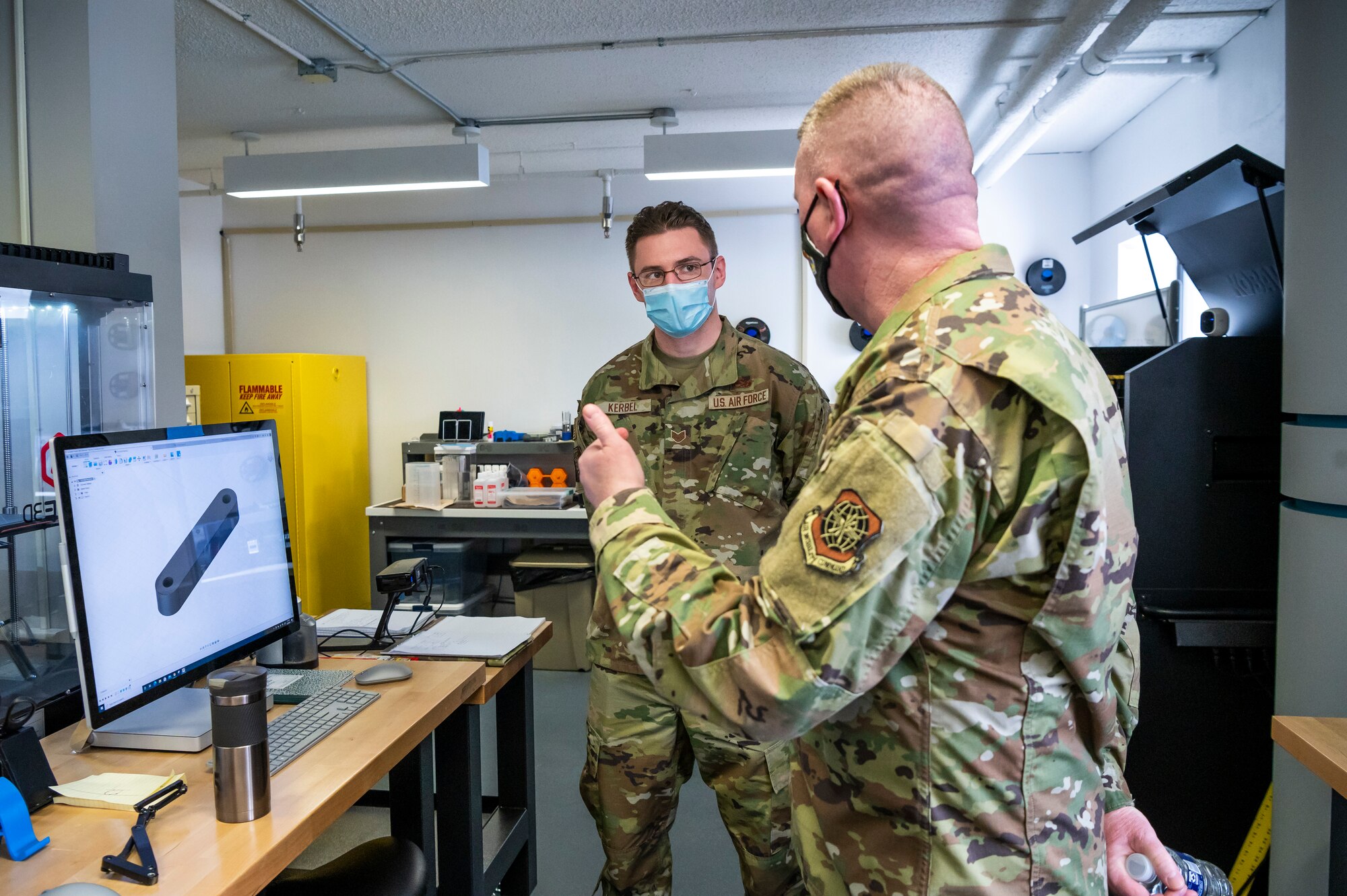 Chief Master Sgt. Chad Bickley, 18th Air Force command chief, speaks with an Airman assigned to the Bedrock innovation lab on Dover Air Force Base, Delaware, Feb. 12, 2021. Established in 2019, Bedrock’s goal is empowering Airmen to develop ideas and leverage new technologies to support the warfighter at home station or downrange. Bedrock’s new facility boasts over 5,000 square feet, housing large, collaborative workspaces, an event stage, a virtual reality classroom, a podcast studio and a prototyping lab with 3D printers. (U.S. Air Force photo by Senior Airman Christopher Quail)