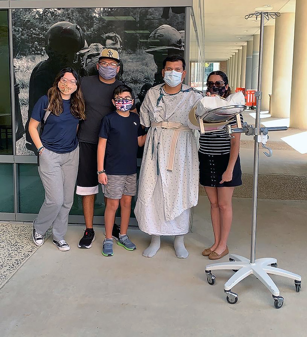 Jorge Terrazas, (second from right), is surrounded by his family (from left), daughter Lesley, sons Aaron and Jorge and wife, Tere, while he was recovering from electrical burn injuries at the U.S. Army Institute of Surgical Research Burn Center at Joint Base San Antonio-Fort Sam Houston.