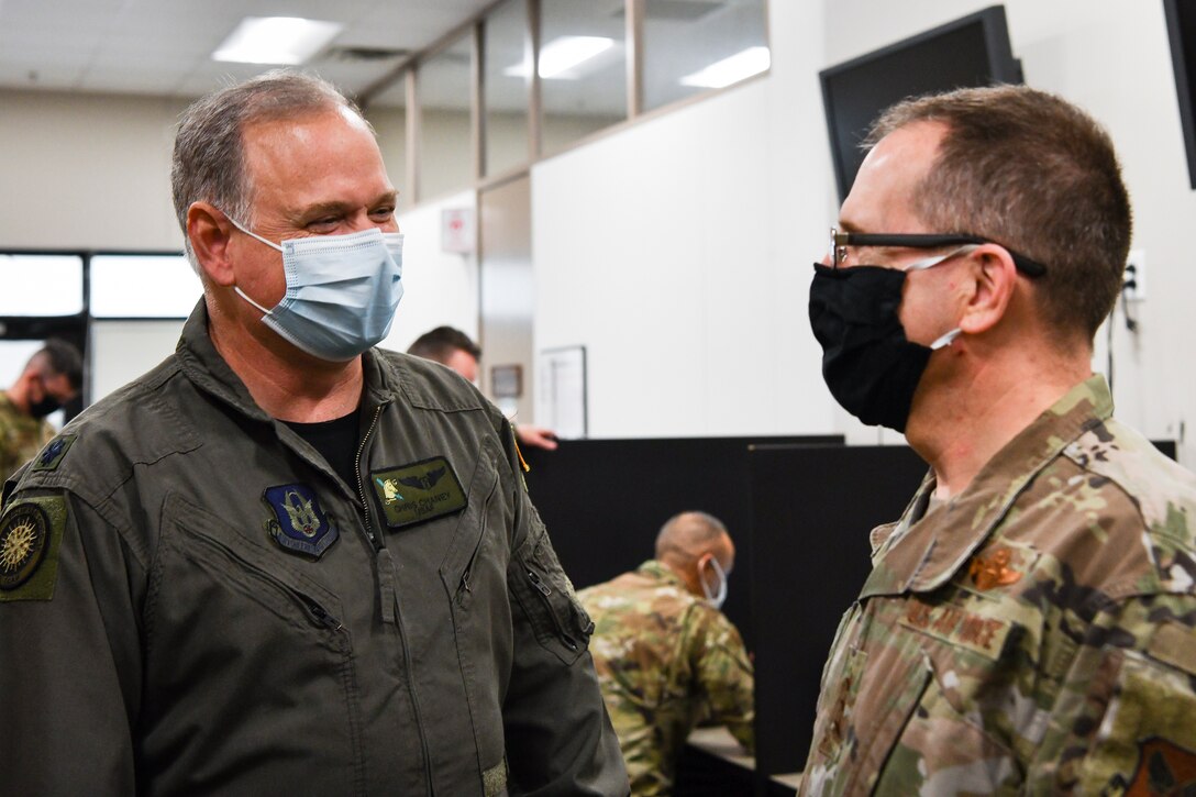 Photo of two Airmen talking to eachother