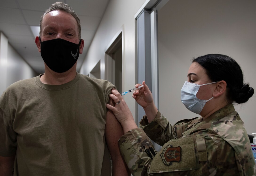 Photo of a medical Airman administering a vaccine