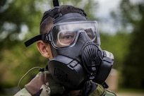 A U.S. Marine assigned to Chemical Biological Radiological and Nuclear (CBRN) Defense School, wears his M50 joint service general-purpose mask during a field training exercise at Fort Leonard Wood, Mo., May 11, 2016. CBRN training teaches Marines how to utilize their issued gear enabling them to survive in a chemical environment.