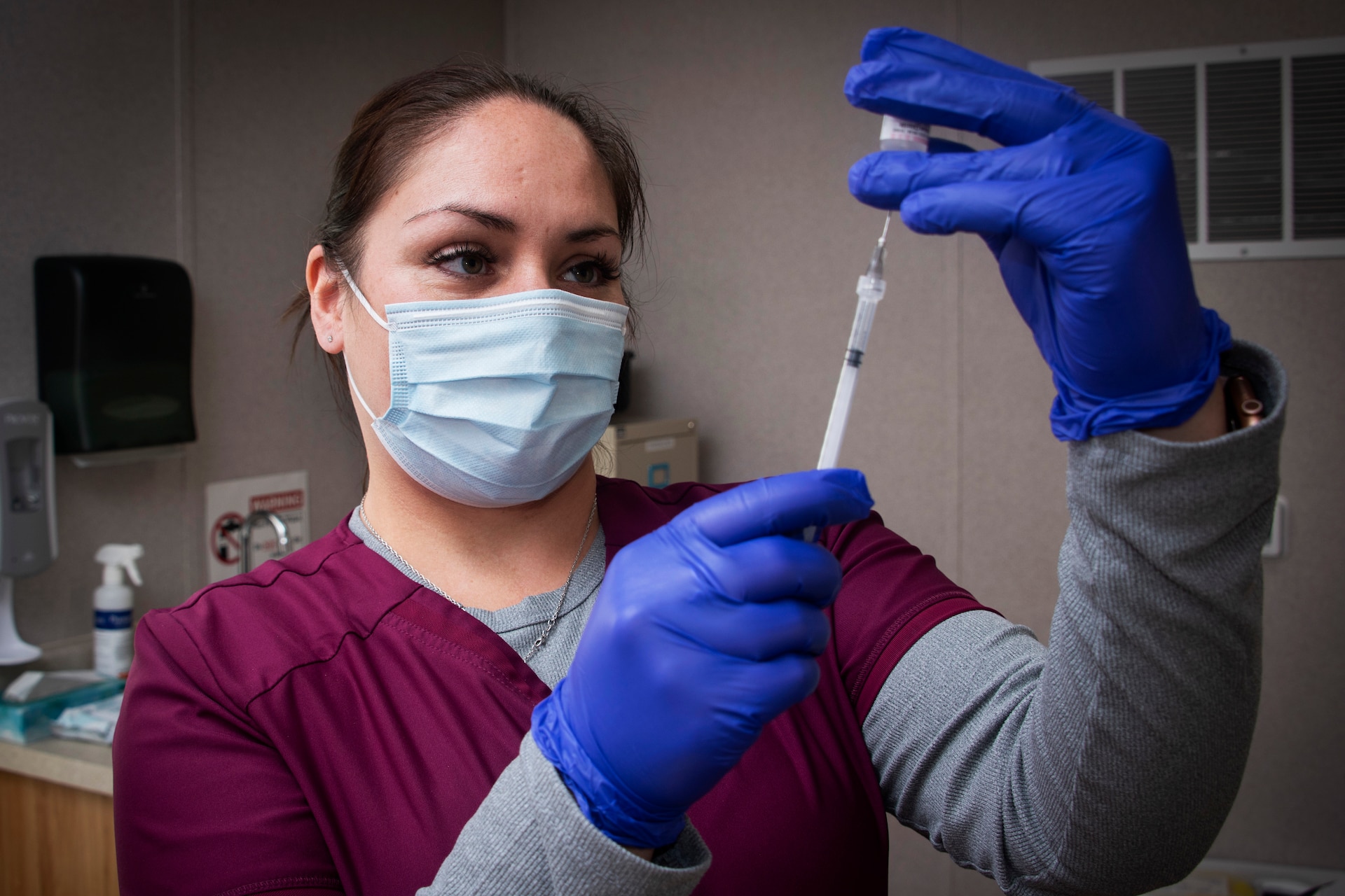 Crystal Tyler, pharmacy technician, prepares an injection for an Operation Warp Speed patient volunteer at Brooke Army Medical Center, Fort Sam Houston, Texas, November 16, 2020. BAMC and Wilford Hall Ambulatory Surgical Center are participating in the Phase III trial to evaluate the vaccine under development by AstraZeneca as part of a national initiative to accelerate the development, production and distribution of COVID-19 vaccines, therapeutics and diagnostics.