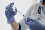Medical professional filling a syringe with the COVID-19 vaccine.