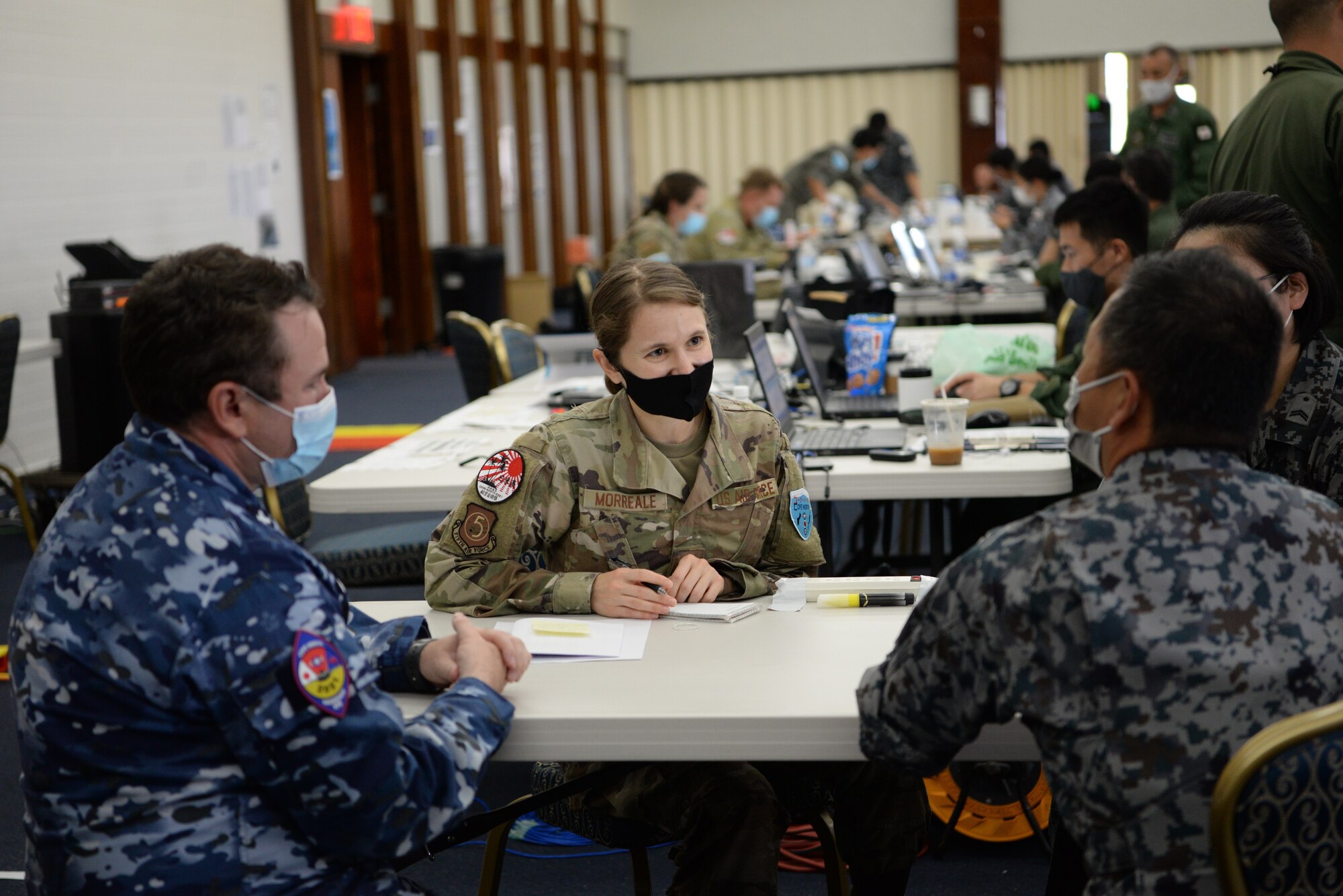 U.S. Air Force Maj. Brittany Morreale, the 5th Air Force A5 division chief and Cope North 21 Interpreter Cell lead, serves as an interpreter for a Japan Air Self-Defense Force, or Koku-Jieitai, and a Royal Australian Air Force member during Cope North 21 at Andersen Air Force Base, Guam,