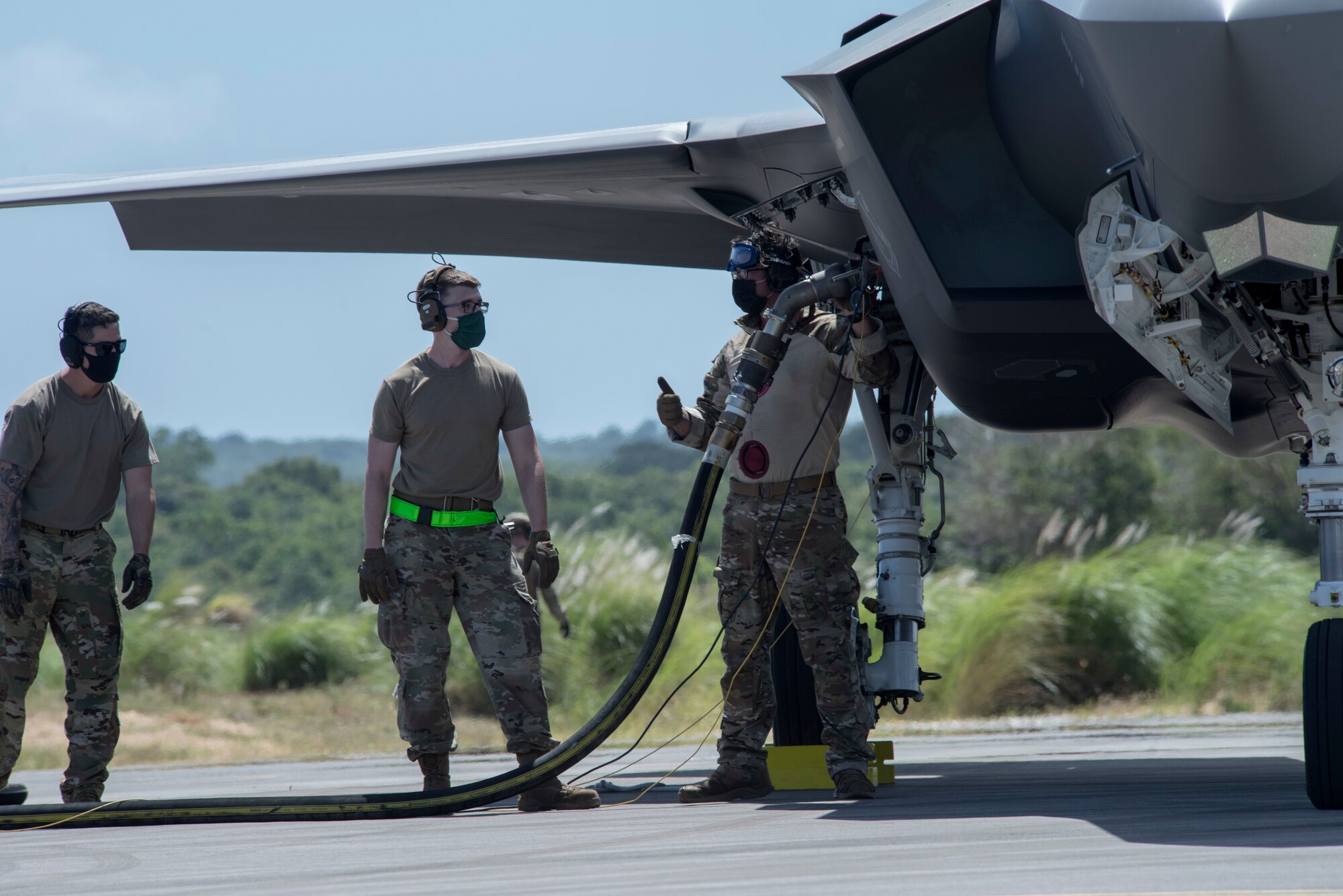 U.S. Air Force Airmen perform hot-pit refueling on an F-35A Lightning II assigned to Eielson Air Force Base, Alaska, at Northwest Field as part of Agile Combat Employment (ACE) multi-capable Airmen training during Cope North 21 at Andersen AFB, Guam, Feb. 16, 2021.