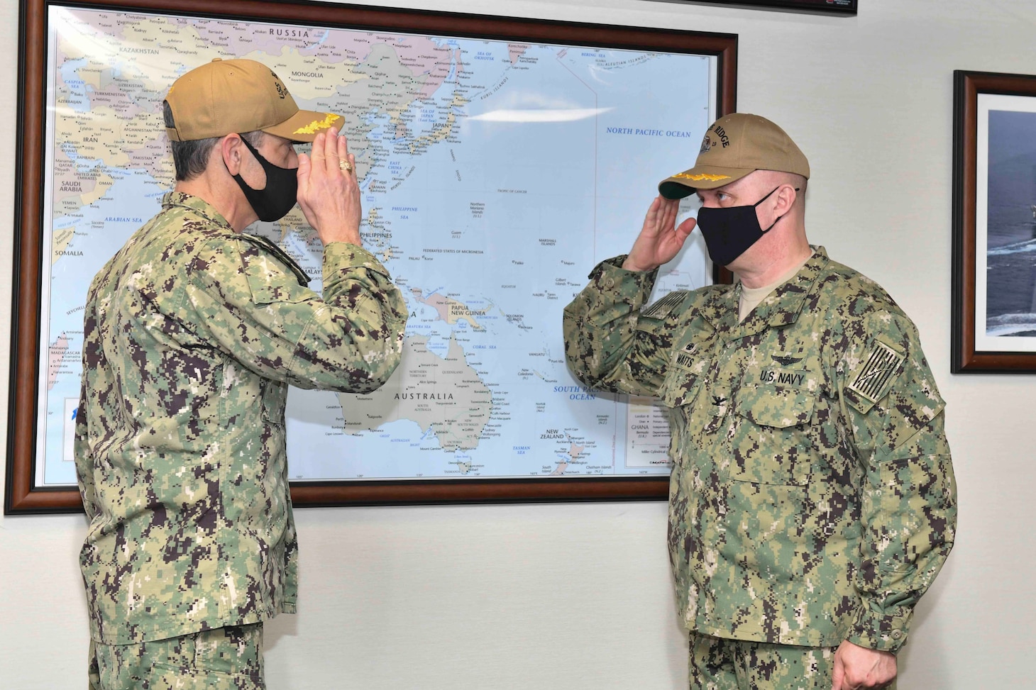 YOKOSUKA, Japan (Feb. 15, 2021) - Outgoing Commanding Officer Capt. Craig Sicola, from Dallas, and newly appointed Commanding Officer Capt. Tim Waits, from Anniston, Alabama, exchange salutes during a change of command ceremony held in the admiral’s cabin aboard U.S. 7th Fleet flagship USS Blue Ridge. Blue Ridge is the oldest operational ship in the Navy and, as 7th Fleet command ship, actively works to foster relationships with allies and partners in the Indo-Pacific Region. (U.S. Navy photo by Mass Communication Specialist 3rd Class Matt Hall)