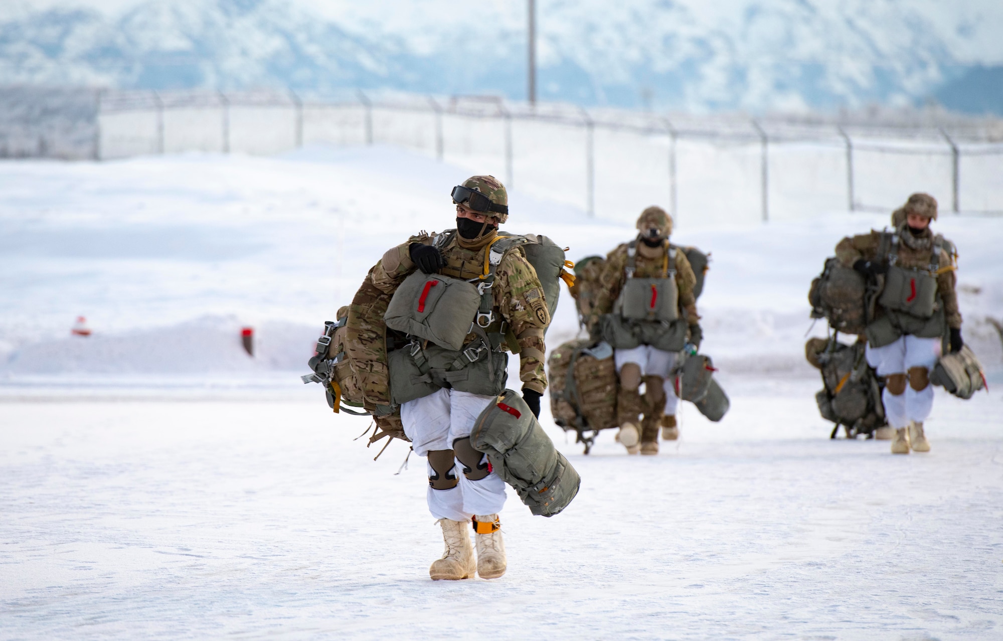 U.S. Army paratroopers, assigned to the 4th Infantry Brigade Combat Team (Airborne), 25th Infantry Division (Spartan Brigade), approach a C-130J Super Hercules, assigned to the 36th Airlift Squadron, Yokota Air Base, Japan, during exercise Arctic Warrior 21 at Joint Base Elmendorf-Richardson, AK, Feb. 8, 2021