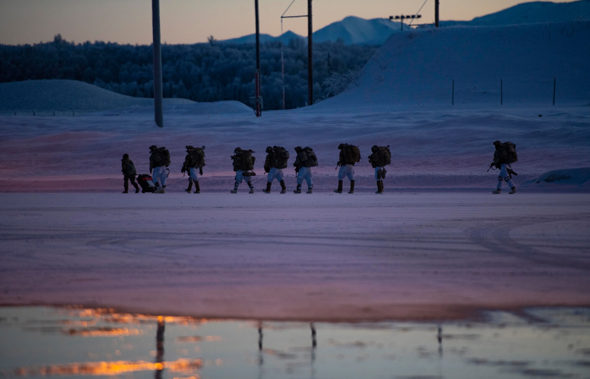U.S. Army paratroopers, assigned to the 4th Infantry Brigade Combat Team (Airborne), 25th Infantry Division (Spartan Brigade), prepare to board a C-130J Super Hercules, assigned to the 36th Airlift Squadron, Yokota Air Base, Japan, during exercise Arctic Warrior 21 at Joint Base Elmendorf-Richardson, AK, Feb. 8, 2021.