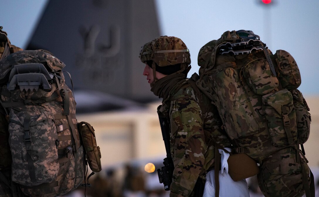 U.S. Army paratroopers, assigned to the 4th Infantry Brigade Combat Team (Airborne), 25th Infantry Division (Spartan Brigade), prepare to board a C-130J Super Hercules, assigned to the 36th Airlift Squadron, Yokota Air Base, Japan, during exercise Arctic Warrior 21 at Joint Base Elmendorf-Richardson, AK, Feb. 8, 2021.