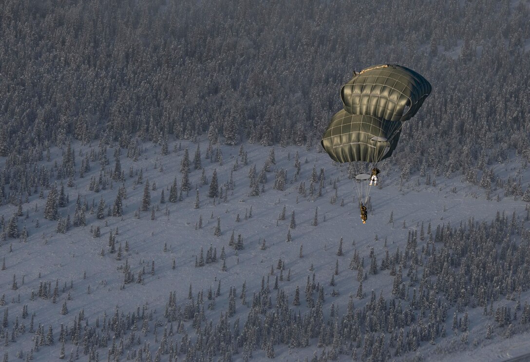 U.S. Army paratroopers, assigned to 4th Infantry Brigade Combat Team (Airborne), 25th Infantry Division (Spartan Brigade), jump out of a C-130J Super Hercules, assigned to the 36th Airlift Squadron, Yokota Air Base, Japan, as part of exercise Arctic Warrior 21 at Donnelly Training Area, AK, Feb. 8, 2021.