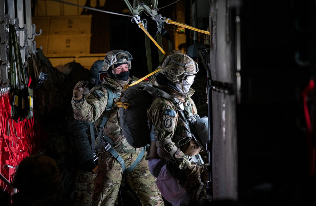 A U.S. Army paratrooper, assigned to 3rd Battalion, 509th parachute infantry regiment, 4th Infantry Brigade Combat Team (Airborne), 25th Infantry Division, jumps out of a C-130J Super Hercules, assigned to the 36th Airlift Squadron, Yokota Air Base, Japan, as part of exercise Arctic Warrior 21 at Donnelly Training Area, AK, Feb. 8, 2021.