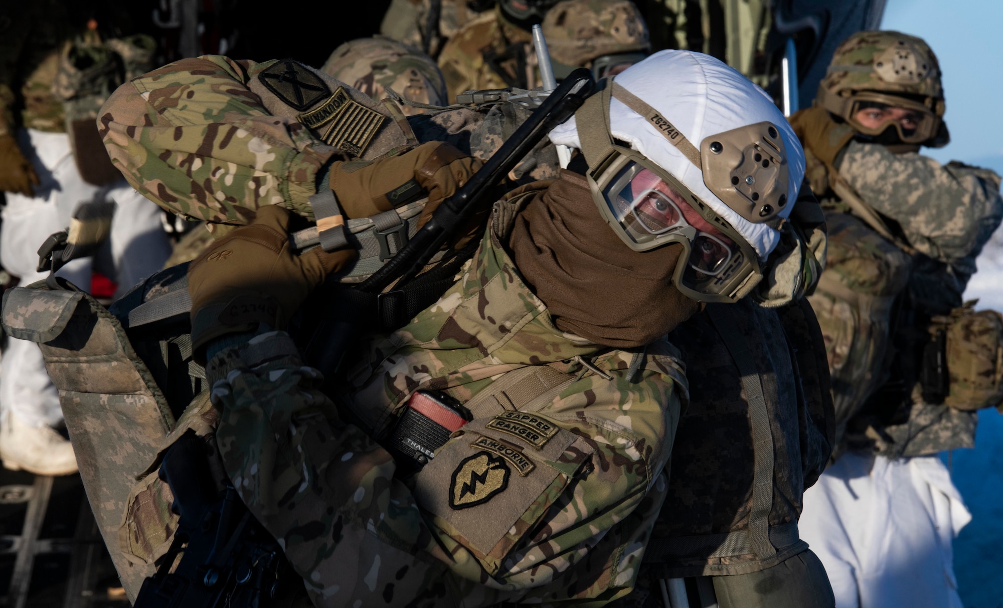 A U.S. Army paratrooper, assigned to 4th Infantry Brigade Combat Team (Airborne), 25th Infantry Division (Spartan Brigade), adjusts his ruck sack as he exit’s a C-130J Super Hercules, assigned to the 36th Airlift Squadron, Yokota Air Base, Japan, as part of exercise Arctic Warrior 21 at Donnelly Training Area, AK, Feb. 8, 2021.