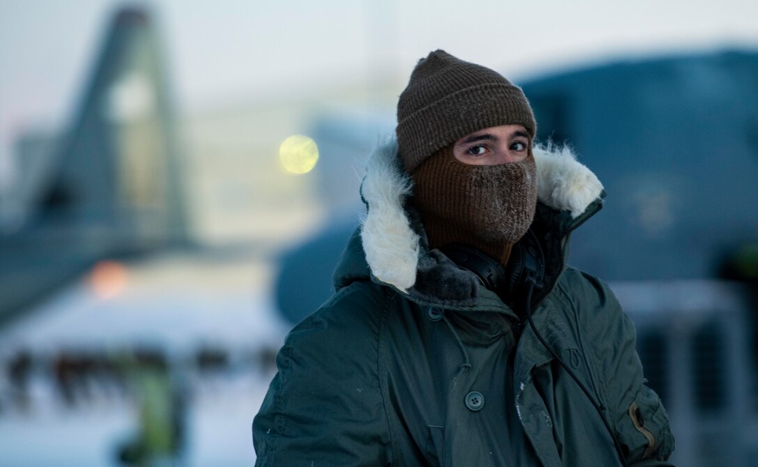 U.S. Air Force Senior Airman Luke Smeltzer, 374th Aircraft Maintenance Squadron crew chief, conducts pre-flight checks on a C-130J Super Hercules during execution day for exercise Arctic Warrior 21 at Joint Base Elmendorf-Richardson, AK, Feb. 8, 2021.
