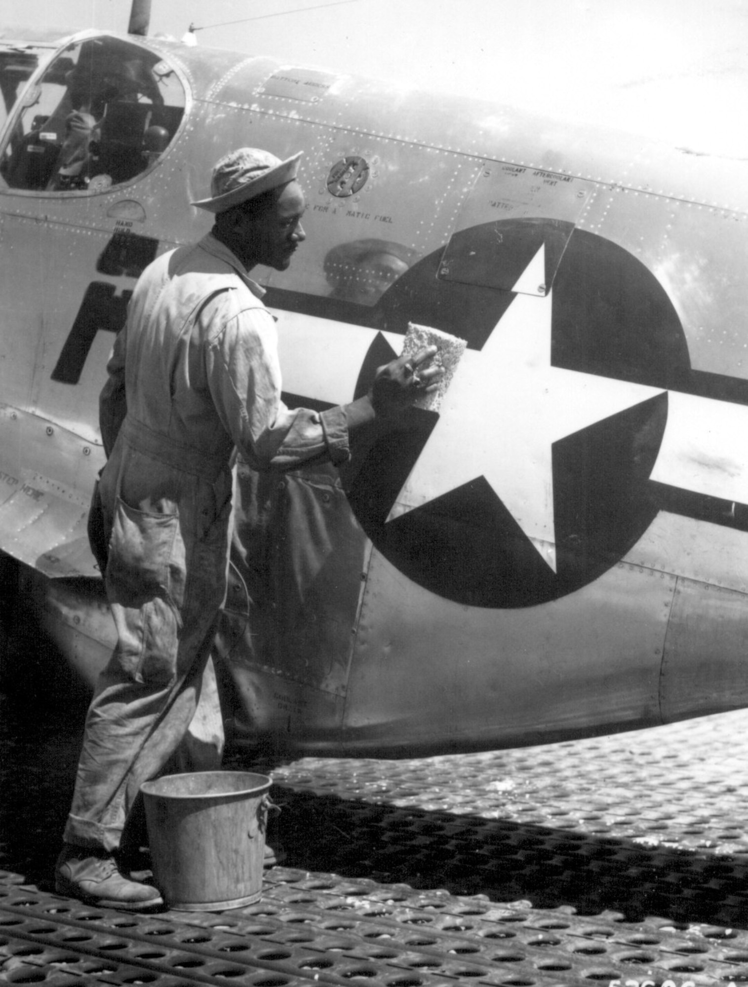 Editor’s note: photo and caption were pulled from the National Archives Catalog.
Staff Sgt. William Accoo, crew chief in a Negro group of the 15th U.S. Air Force, washes down the P-51 Mustang fighter plane of his pilot with soap and water before waxing it to give it more speed. 
Ca. September 1944. 208-AA-46BB-30.