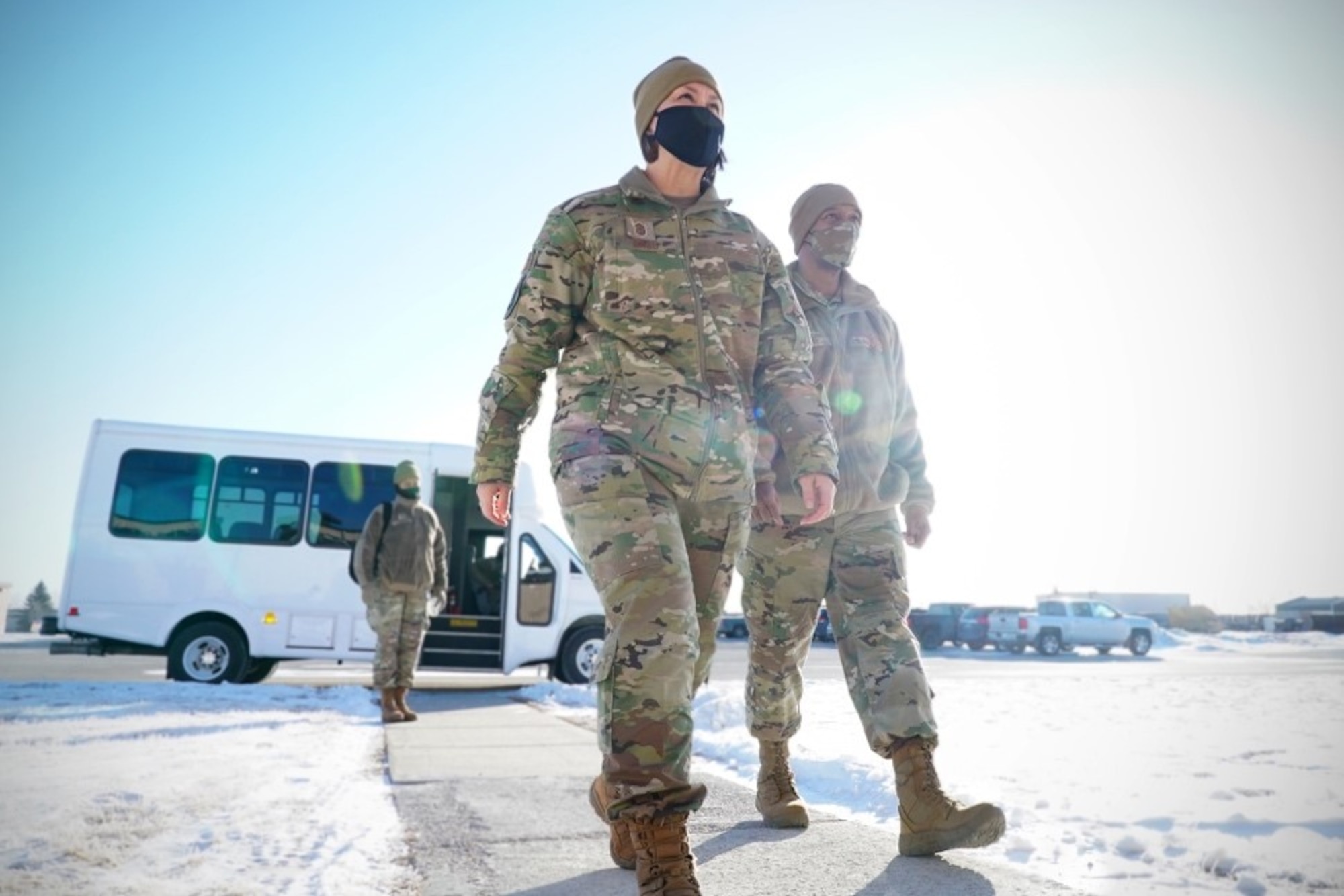 Chief Master Sgt. of the Air Force JoAnne S. Bass, left, and Chief Master Sgt. Nathaniel Perry, Air Force first sergeant special duty manager, arrive at an all-call at Grand Forks Air Force Base, N.D., Feb. 12, 2021. The pair participated in an open discussion with an audience of Airmen who had questions about current Air Force policies, social media boundaries for military members and general expectations for the future of the Air Force.