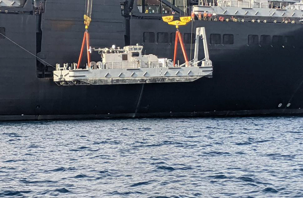 Sailors deployed as the expeditionary logistics and cargo handling capability of Task Force 75 operate a crane to lift off USNS Pililaau (T-AK 304) with Maritime Prepositioning Ships Squadron 3 on U.S. Naval Base Guam.