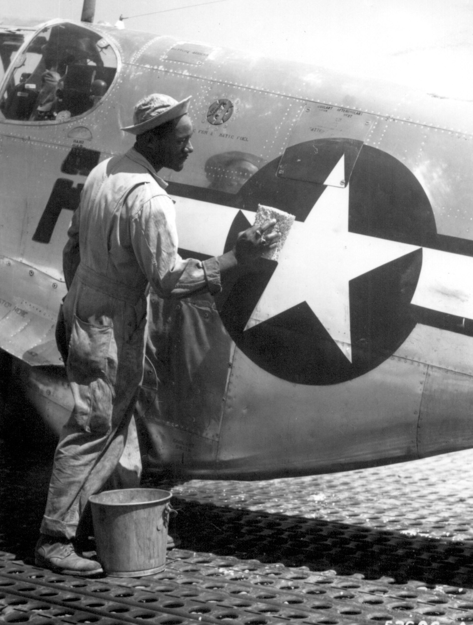 Editor’s note: photo and caption were pulled from the National Archives Catalog.
Staff Sgt. William Accoo, crew chief in a Negro group of the 15th U.S. Air Force, washes down the P-51 Mustang fighter plane of his pilot with soap and water before waxing it to give it more speed. 
Ca. September 1944. 208-AA-46BB-30.