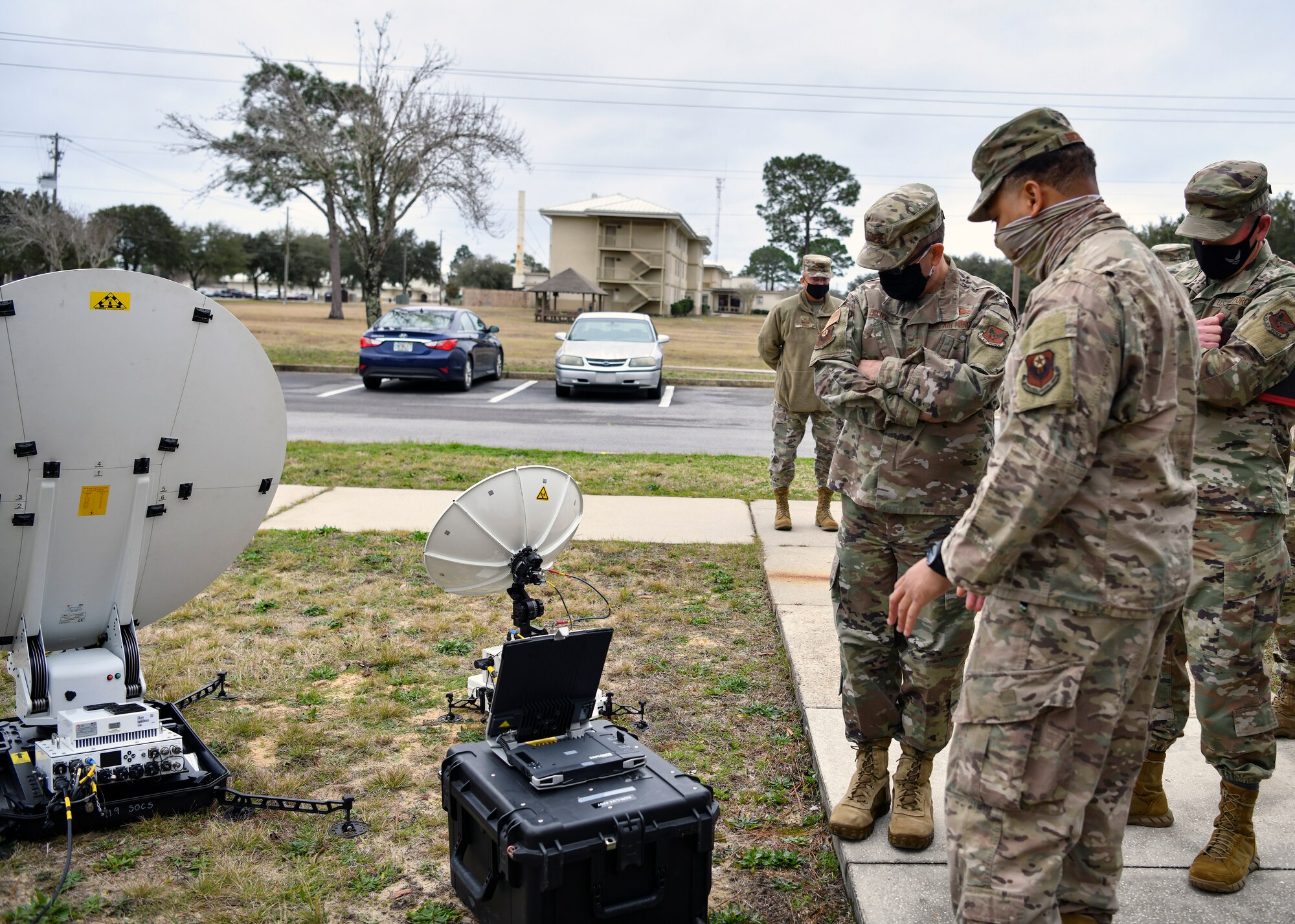 Photo of Airmen looking at satellite dishes