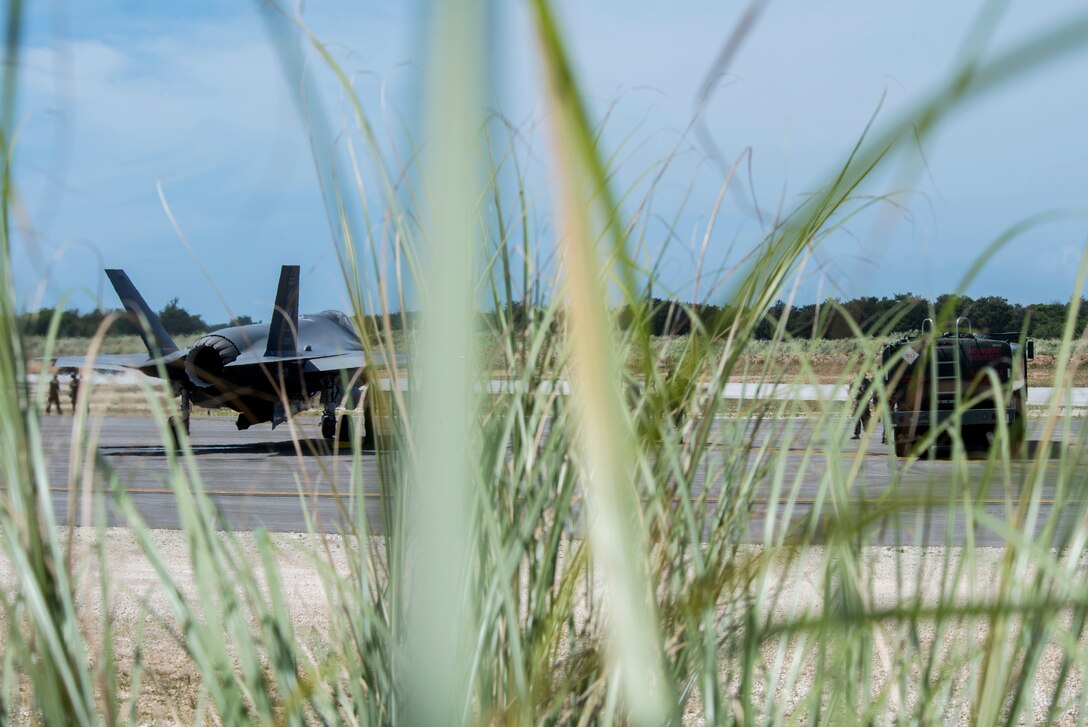 An F-35A Lightning II assigned to Eielson Air Force Base, Alaska, awaits to refuel from an R-11 fuel truck at Northwest Field as part of Agile Combat Employment (ACE) multi-capable Airmen training during Cope North 21 at Andersen AFB, Guam, Feb. 16, 2021.
