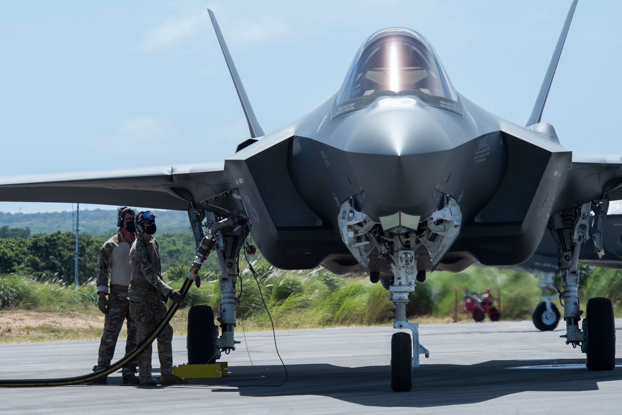 U.S. Air Force Airmen perform hot-pit refueling on an F-35A Lightning II assigned to Eielson Air Force Base, Alaska, at Northwest Field as part of Agile Combat Employment (ACE) multi-capable Airmen training during Cope North 21 at Andersen AFB, Guam, Feb. 16, 2021.