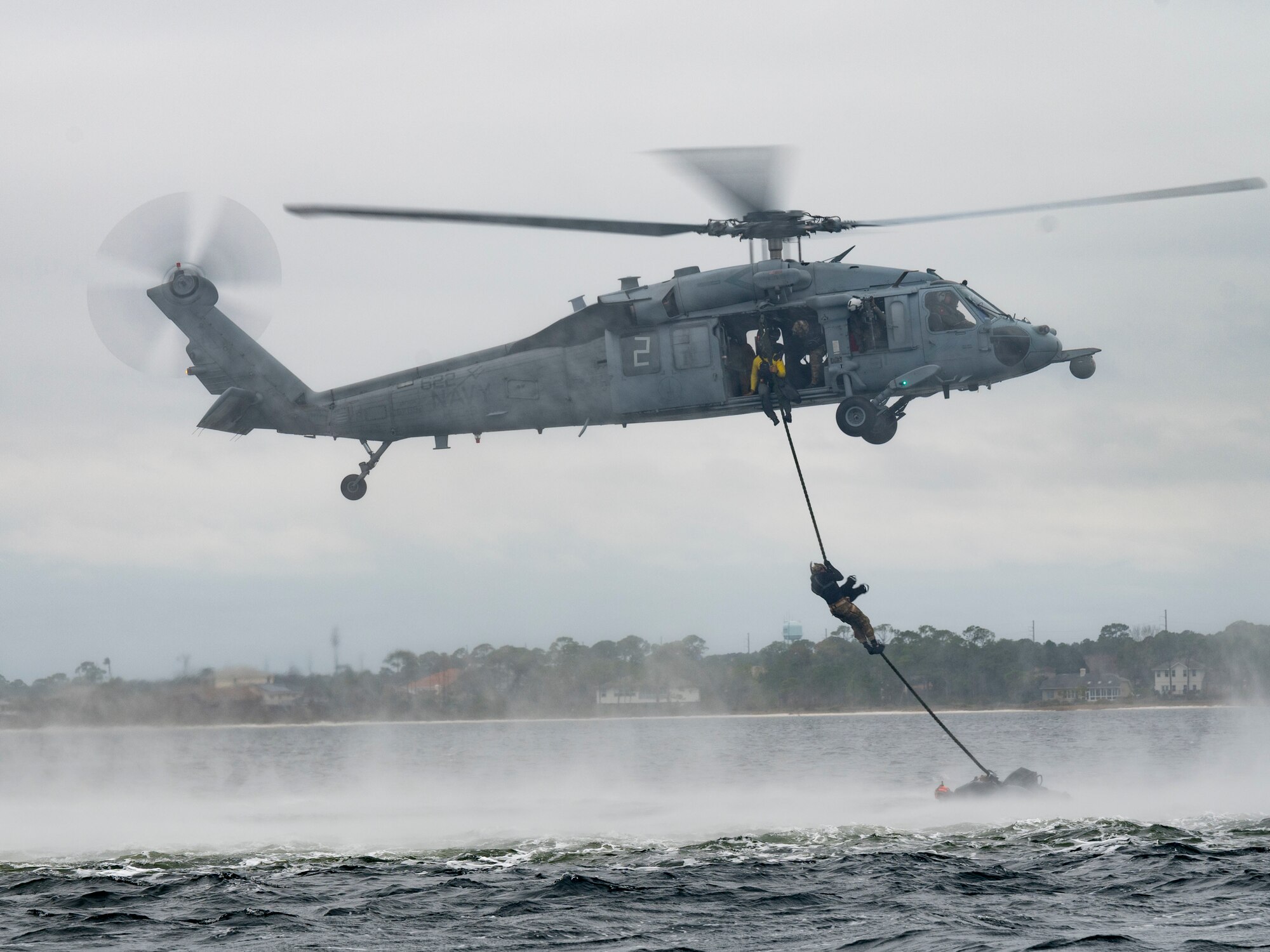 U.S. Air Force Special Tactics operators assigned to the 24th Special Operations Wing, conduct hoist operations with U.S. Navy MH-60 Seahawk aircrew members assigned to Helicopter Sea Combat Squadron Nine, during Emerald Warrior 21.1, at Hurlburt Field, Fla., Feb. 18, 2021.