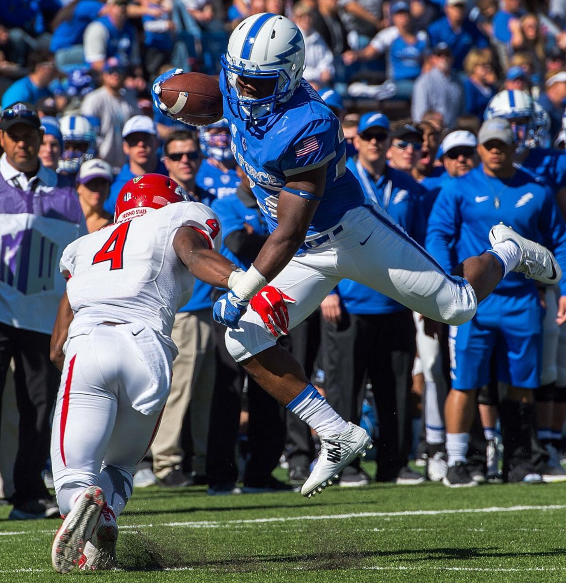 1st Lt. Bryan Driskell (right), an AC-130W Stinger II aircraft pilot with the 16th Special Operations Squadron, at the time a cadet, dodges a blocker during his first carry as a running back for the Air Force Academy football team against Fresno State University at Colorado Springs, Colorado. Until his senior year in high school, Driskell planned to become a professional football player. (Courtesy Photo)