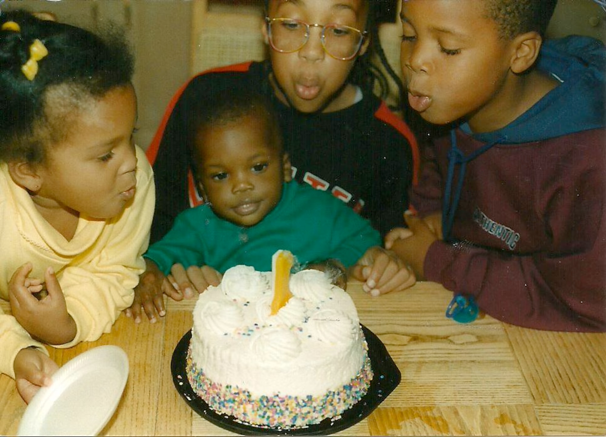 A young 1st Lt. Bryan Driskell (middle lower), an AC-130W Stinger II aircraft pilot with the 16th Special Operations Squadron, celebrates his first birthday with his siblings at McKinney, Texas. Driskell grew up surrounded by sports and was sure he would go to school for sports until his senior year of high school. (Courtesy Photo)