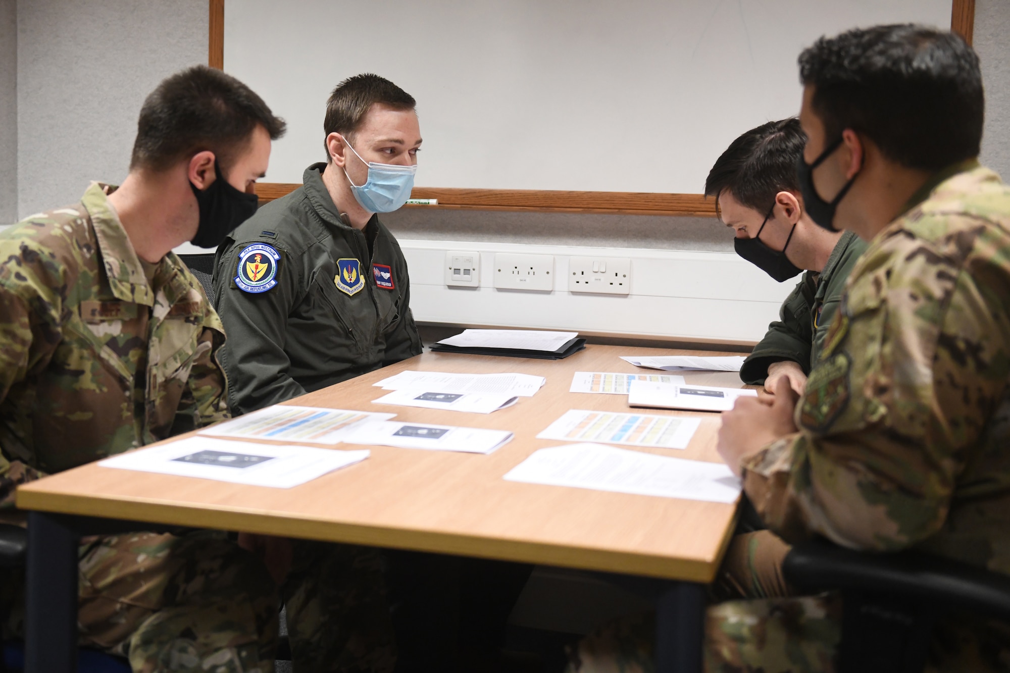 A Tanker Heist team of aircrew members receives a pre-mission brief prior to their turn in the KC-135 Stratotanker aircraft flight simulator at Royal Air Force Mildenhall, England, Feb. 11, 2021. During this time, each team determined how best to execute maneuvers in accordance with KC-135 manuals and directives and Air Force tactics, techniques and procedures. (U.S. Air Force photo by Staff Sgt. Mackenzie Mendez)