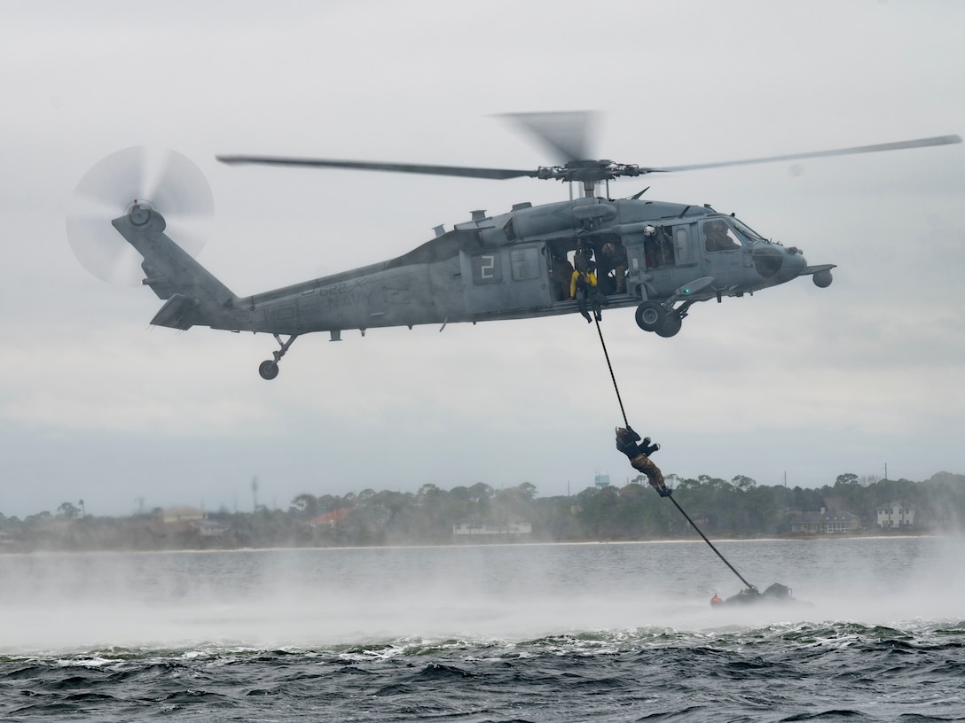 U.S. Air Force Special Tactics operators assigned to the 24th Special Operations Wing, conduct hoist operations with U.S. Navy MH-60 Seahawk aircrew members assigned to Helicopter Sea Combat Squadron Nine, during Emerald Warrior 21.1, at Hurlburt Field, Fla., Feb. 18, 2021.