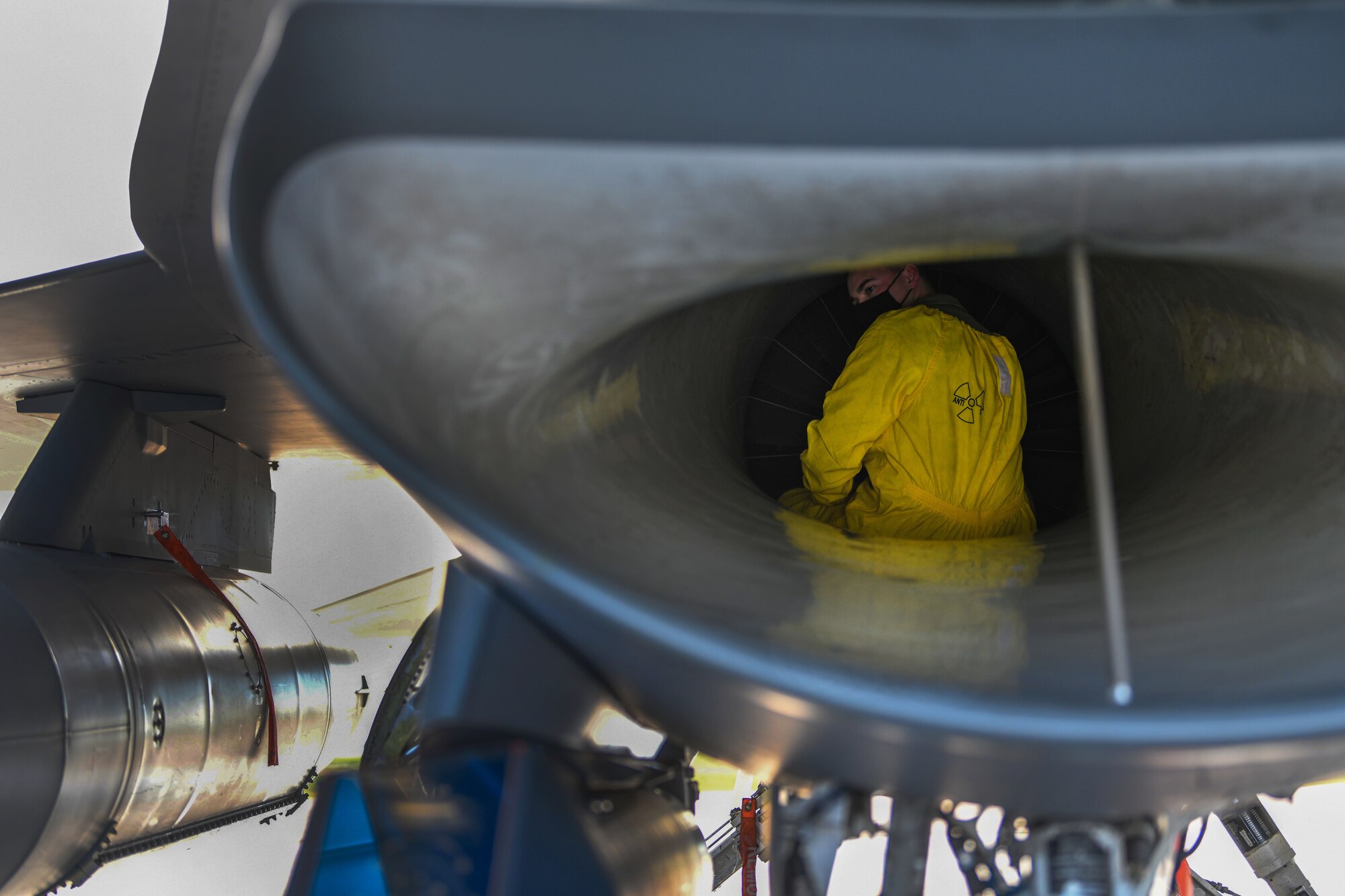 U.S. Air Force Senior Airman William Hambleton, 31st Aircraft Maintenance Squadron crew chief, inspects the intake of an F-16 Fighting Falcon during an Agile Combat Employment exercise at Amendola Air Base, Italy, Feb. 16, 2021. Hambleton climbed into the intake to check the engine blades for dents and cracks. (U.S. Air Force photo by Senior Airman Ericka A. Woolever)
