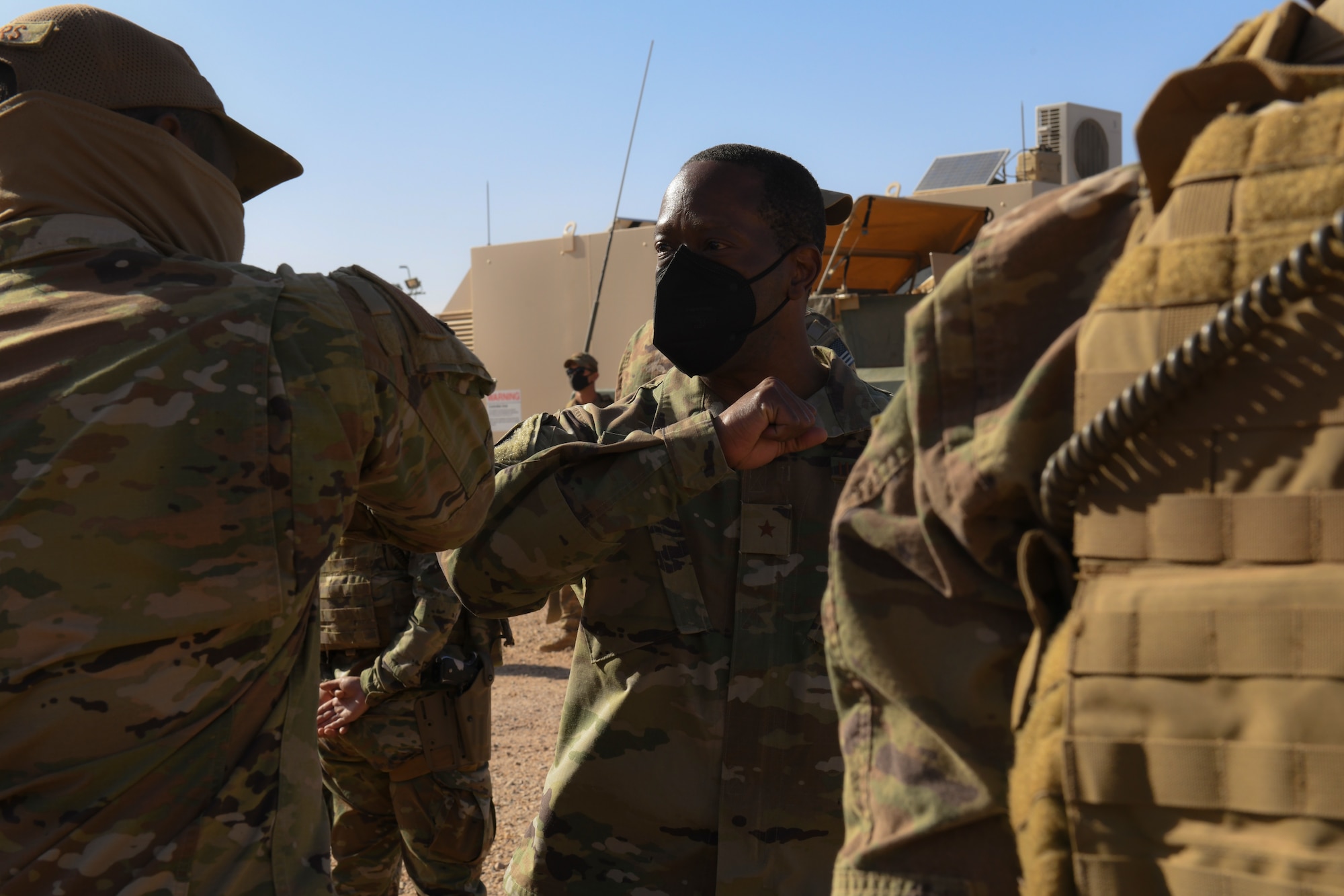U.S. Air Force Brig. Gen. Ronald E. Jolly Sr., Headquarters U.S. Air Forces in Europe and Air Forces Africa director of logistics, engineering and force protection, bumps elbows with a 409th Expeditionary Security Forces Squadron member during a visit to Nigerien Air Base 201, Agadez, Niger, Feb. 6, 2021. The visit focused on security forces, force protection elements across all U.S. Africa Command locations, to include on-going civil engineering projects that relate to or enhance force protection at each location. (U.S. Air Force photo by Senior Airman Gabrielle Winn)