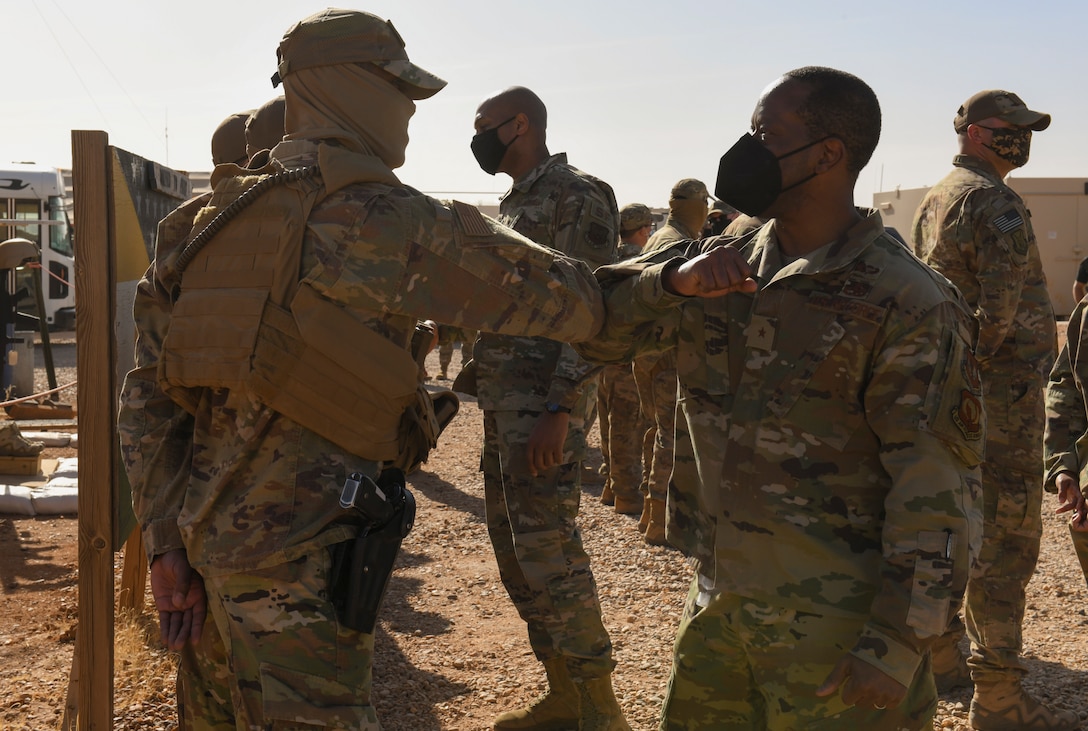 U.S. Air Force Brig. Gen. Ronald E. Jolly Sr., Headquarters U.S. Air Forces in Europe and Air Forces Africa director of logistics, engineering and force protection and Brig. Gen. Roy W. Collins, Headquarters U.S. Air Force director of security forces and deputy chief of staff for logistics, engineering and force protection, greets 409th Expeditionary Security Forces Squadron members during their visit to Nigerien Air Base 201, Agadez, Niger, Feb. 6, 2021. The 409 ESFS defend the base and its assets through constant patrols, vehicle inspections and the vetting of all personnel working on the installation. (U.S. Air Force photo by Senior Airman Gabrielle Winn)