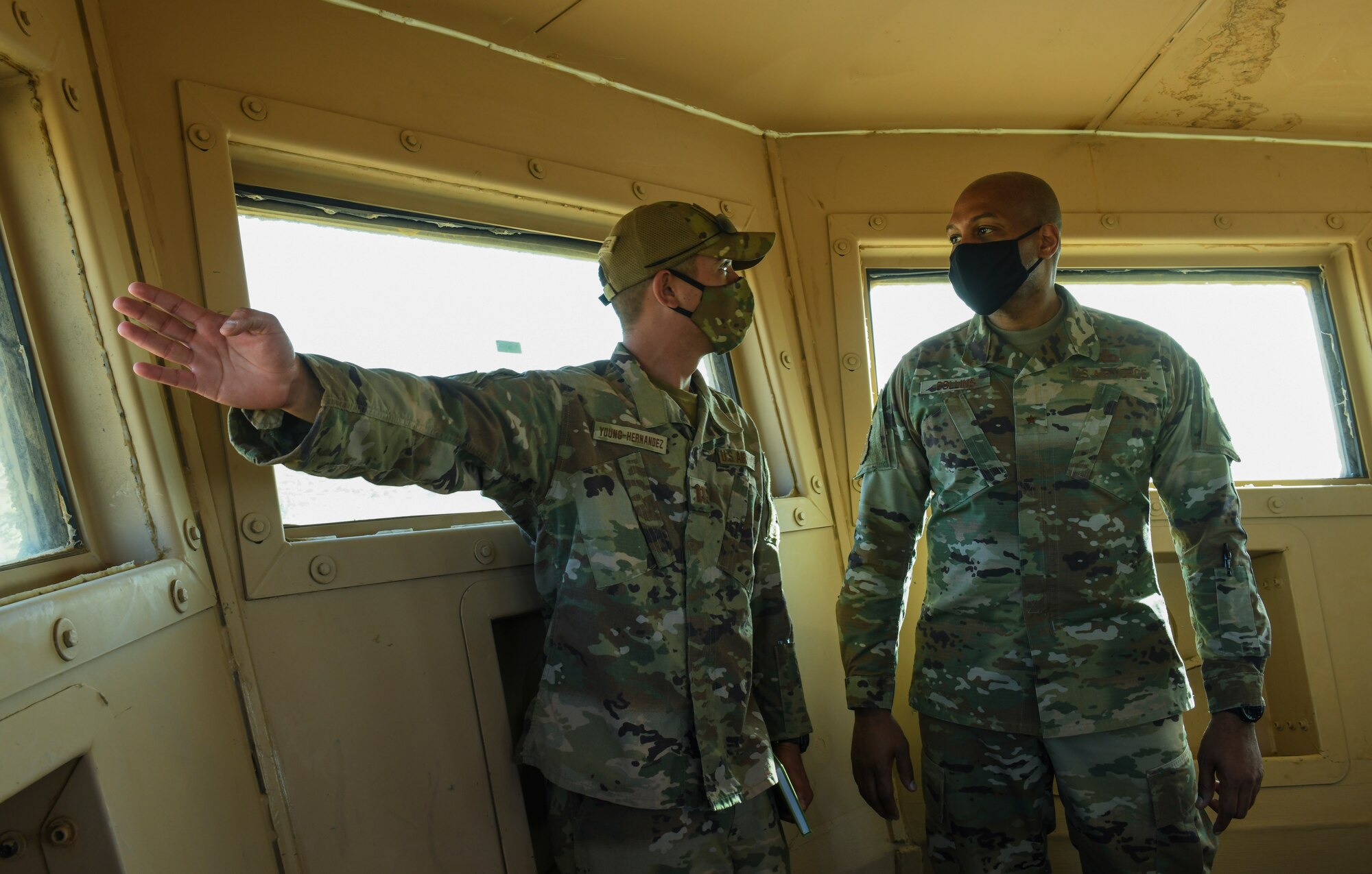 U.S. Air Force Brig. Gen. Roy W. Collins, Headquarters U.S. Air Force director of security forces and deputy chief of staff for logistics, engineering and force protection, receives a tour of a look-out tower from Capt. Malcolm Young-Hernandez, 409th Expeditionary Security Forces Squadron operations officer, during a visit to Nigerien Air Base 201, Agadez, Niger, Feb. 6, 2021. The visit focused on security forces, force protection elements across all U.S. Africa Command locations, to include on-going civil engineering projects that relate to or enhance force protection at each location. (U.S. Air Force photo by Senior Airman Gabrielle Winn)