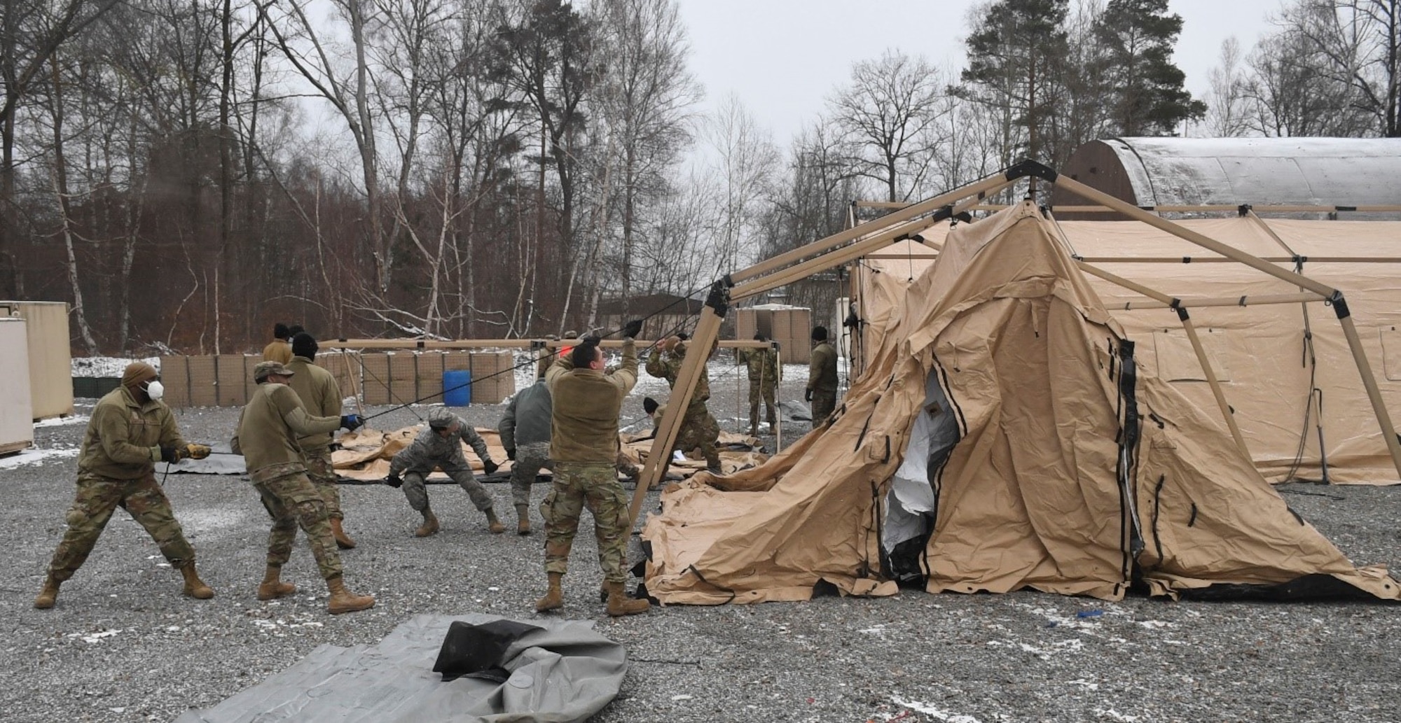 Members of the 52nd Civil Engineer Squadron from Spangdahlem Air Base, Germany, construct a tent at Ramstein Air Base, Germany, Feb. 10, 2021.