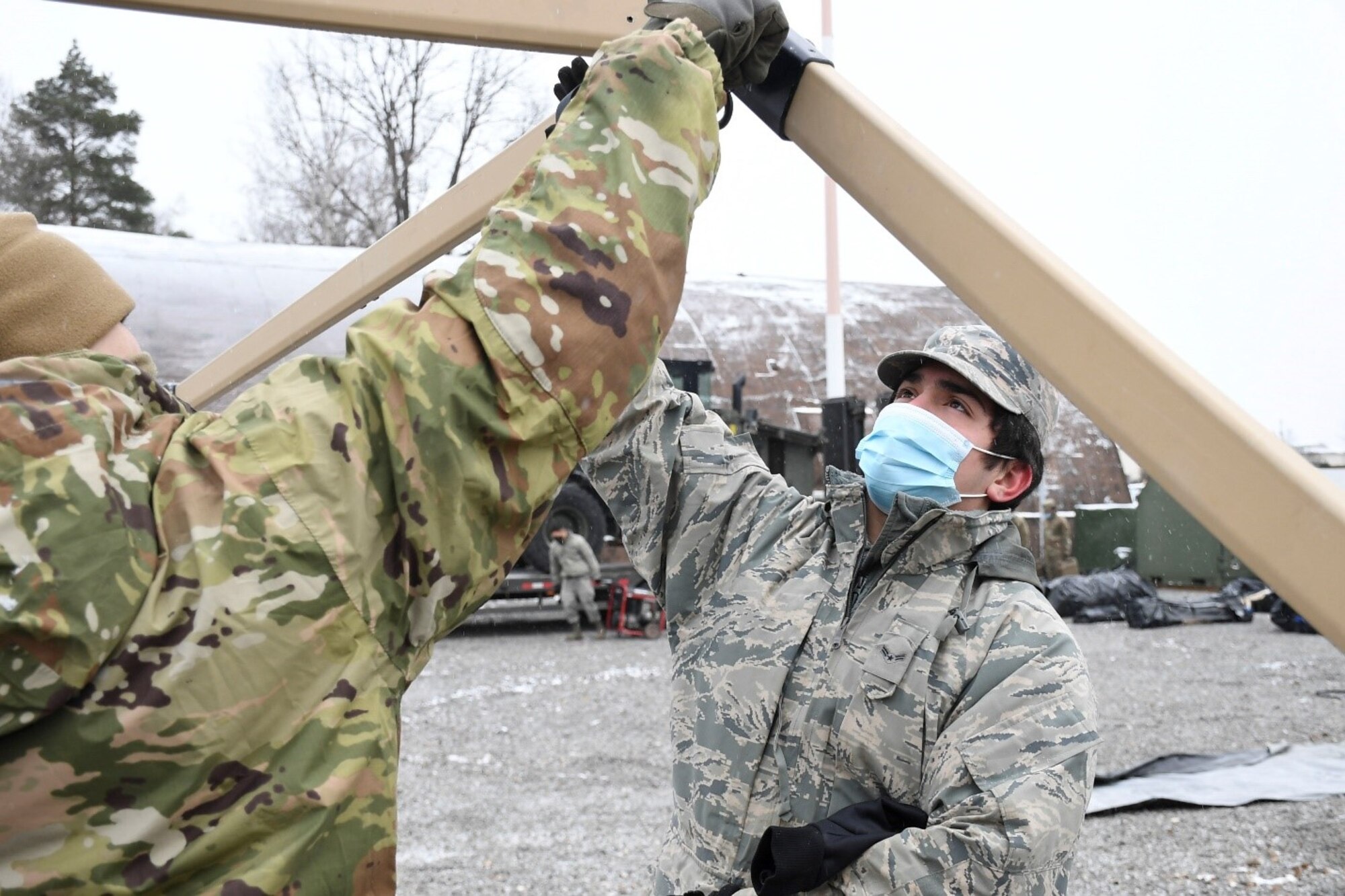 Members of the 52nd Civil Engineer Squadron from Spangdahlem Air Base, Germany, construct a tent during a CBRN response training exercise at Ramstein Air Base, Germany, Feb. 10, 2021.