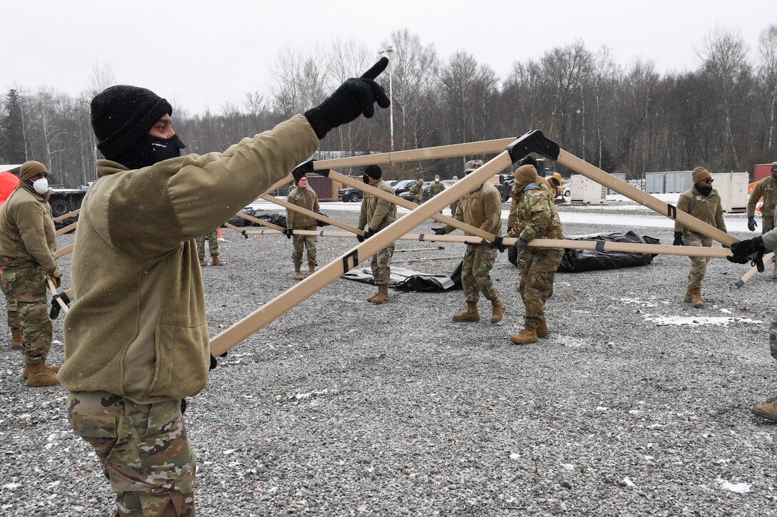 Members of the 52nd Civil Engineer Squadron from Spangdahlem Air Base, Germany, construct a tent at Ramstein Air Base, Germany, Feb. 10, 2021.