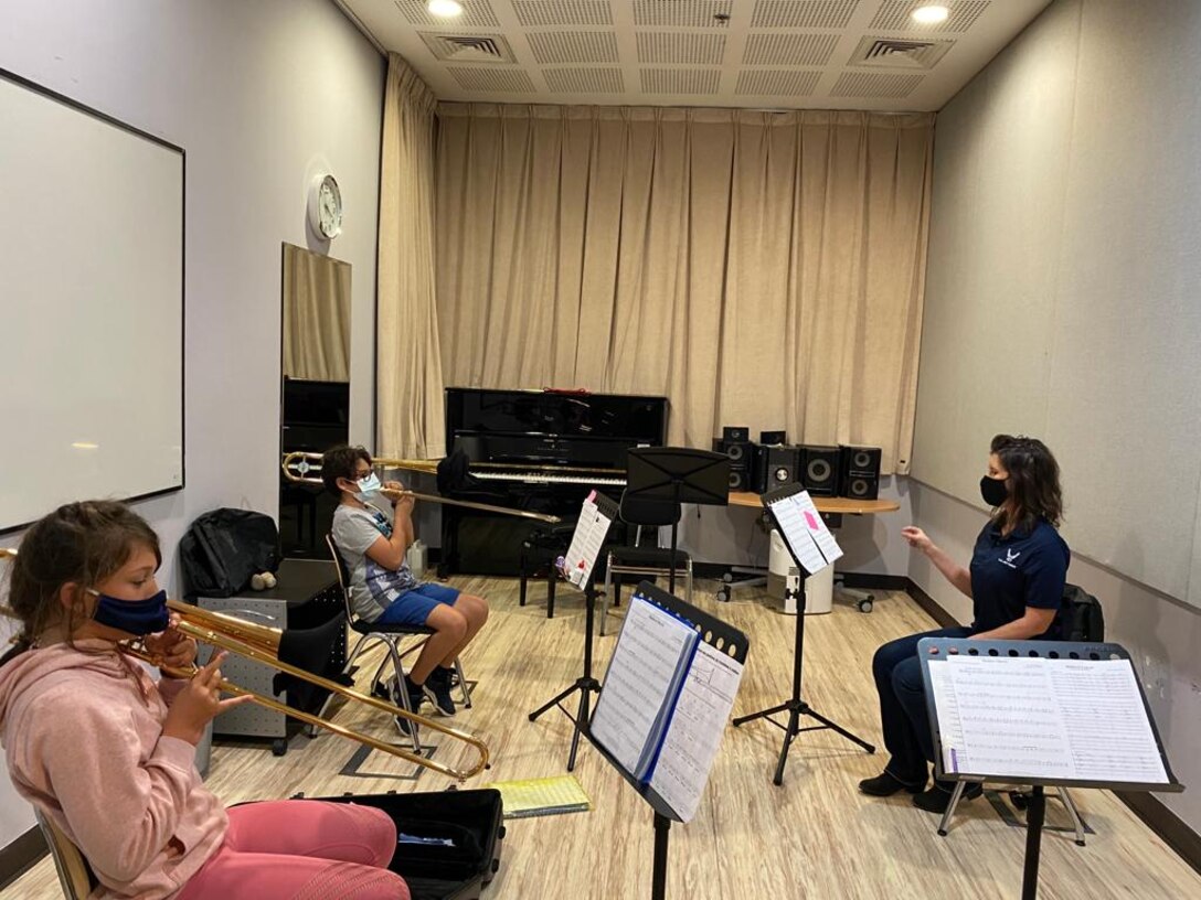 U.S. Air Force Master Sgt. Lisa Drefke, superintendent of the U.S. Air Forces Central Band, works with trombone students at the Qatar Music Academy in Doha, Qatar, February 16, 2021