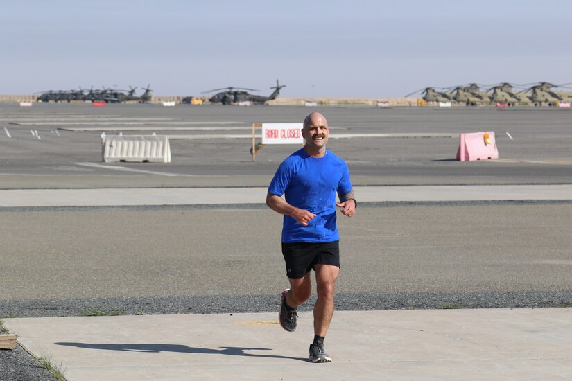 U.S. Army Sgt. 1st Class Mark Good, personnel specialist with Headquarters Support Company, 628th Aviation Support Battalion, approaches the finish line of the Task Force Anvil Marathon. About 120 Soldiers raced in memory of Michael J. Novosel, Sr., a native of Etna, Pennsylvania, who served for over 40 years as an Army aviator and received the Medal of Honor for rescuing 29 Soldiers during the Vietnam War.