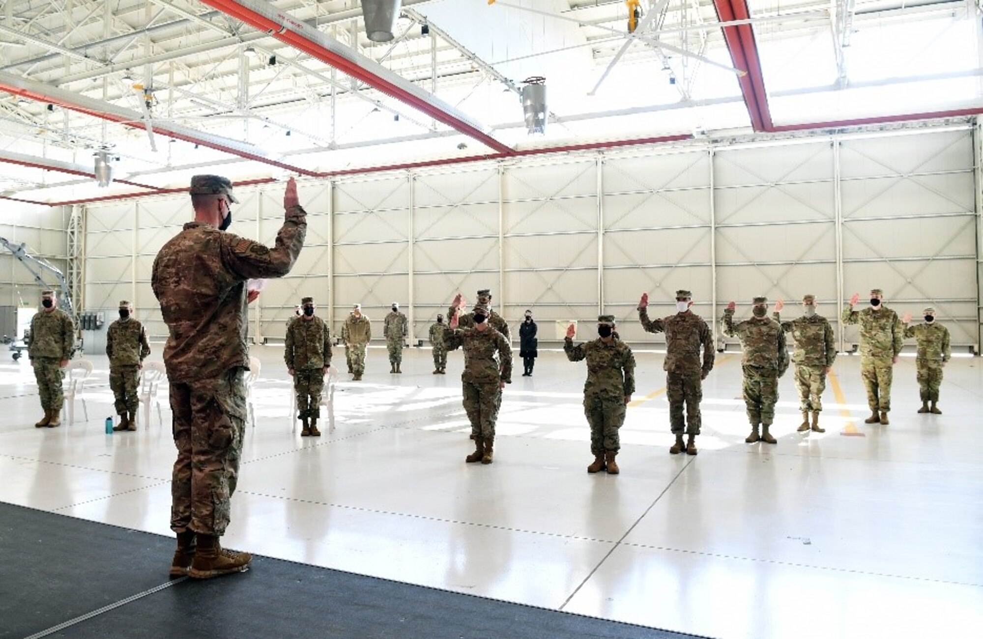 U.S. Air Force Brig Gen. Jason Bailey, 31st Fighter Wing commander, recites the oath of enlistment to Airmen from 31st FW during their transfer ceremony into the United States Space Force at Aviano Air Base, Italy, Feb. 16, 2021.