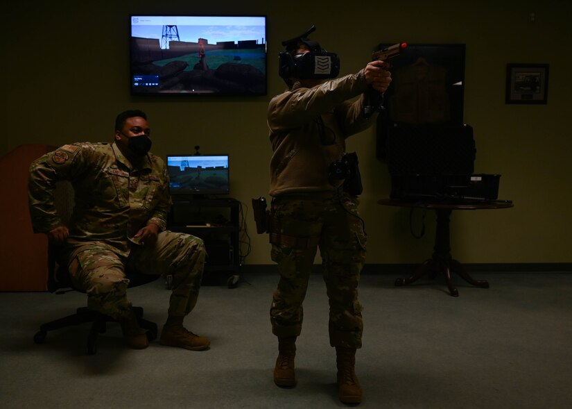 U.S. Air Force Senior Airman Breana Bebee, 633rd Security Forces Squadron unit appointment manager, and Staff Sgt. David Griffin, 633rd SFS Non-Commissioned Officer In-Charge of training, use virtual reality training to test reactions to various use-of-force scenarios Feb. 3, 2021, at Joint Base Langley-Eustis, Virginia.
