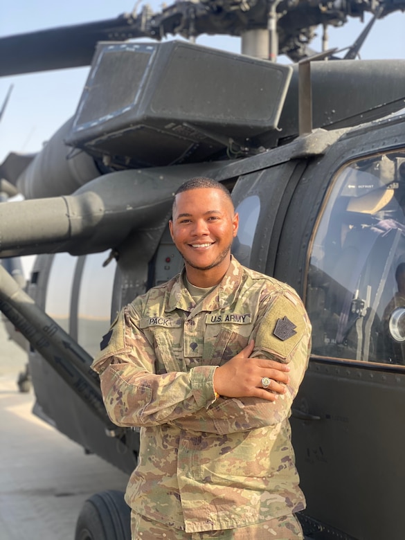 Spc. John Pack, a signal support specialist with 1st Battalion, 137th Aviation Regiment, poses for a photo after performing a radio check on a UH-60 Blackhawk.  Spc. Pack is credited for using Bystander Intervention to set a positive climate for Soldiers assigned to the 28th Expeditionary Combat Aviation Brigade.