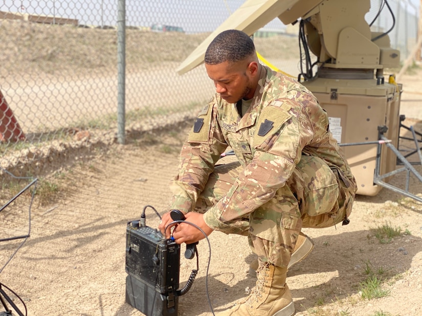 Spc. John Pack, deployed with the 1st Battalion, 137th Aviation Regiment, performs a radio check after setting up telecommunication equipment.  Spc. Pack is currently deployed in support of Operation INHERENT RESOLVE and Operation SPARTAN SHIELD.