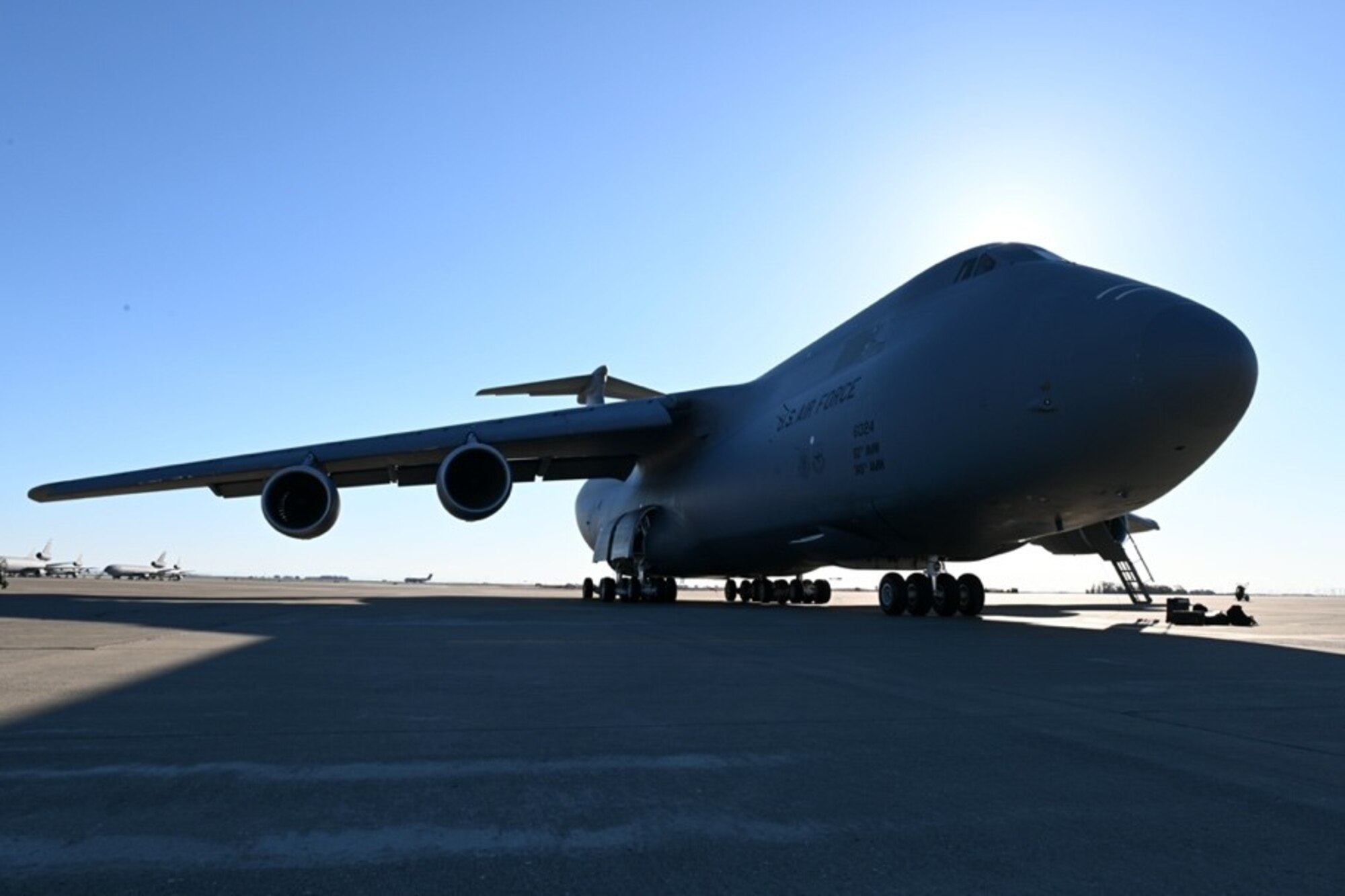 A C-5M Super Galaxy is parked on a flight line