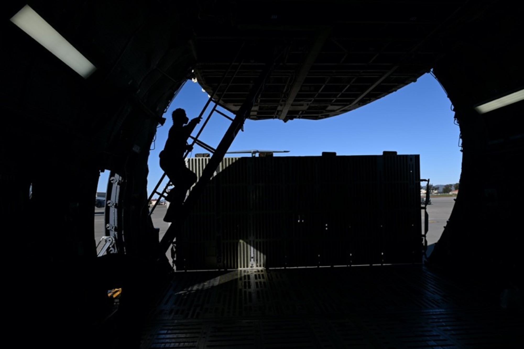 An Airman walks up the stairs into the second level of a C-5M Super Galaxy